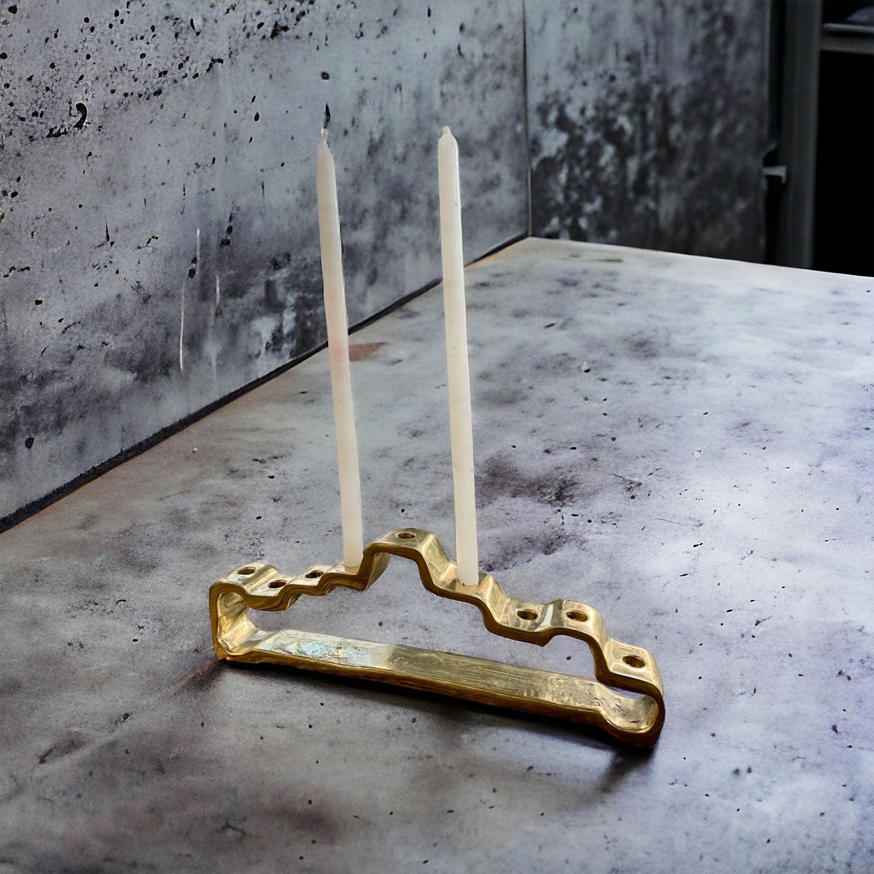 The decorative Menorah was created by David Marshall, it is made of  sand cast brass. 
Handmade, mounted and finished in our foundry and workshop in Spain from recycled materials.
Certified authentic by the Artist David Marshall with his