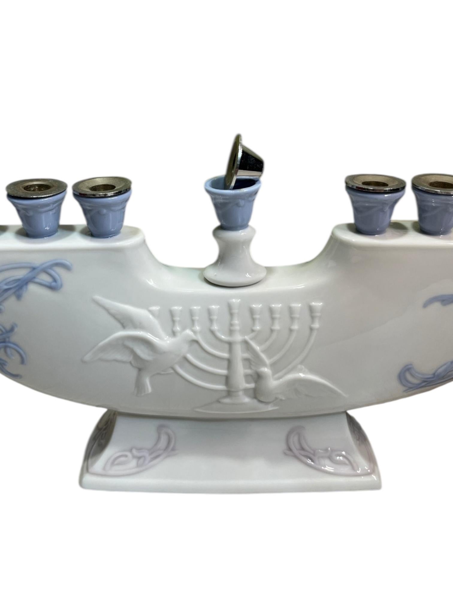 Celebrate the Festival of Lights with timeless elegance through this exquisite Lladró Menorah Candleholder, a masterful blend of spiritual tradition and fine porcelain artistry. Crafted in Spain by the world-renowned Lladró atelier, this unique