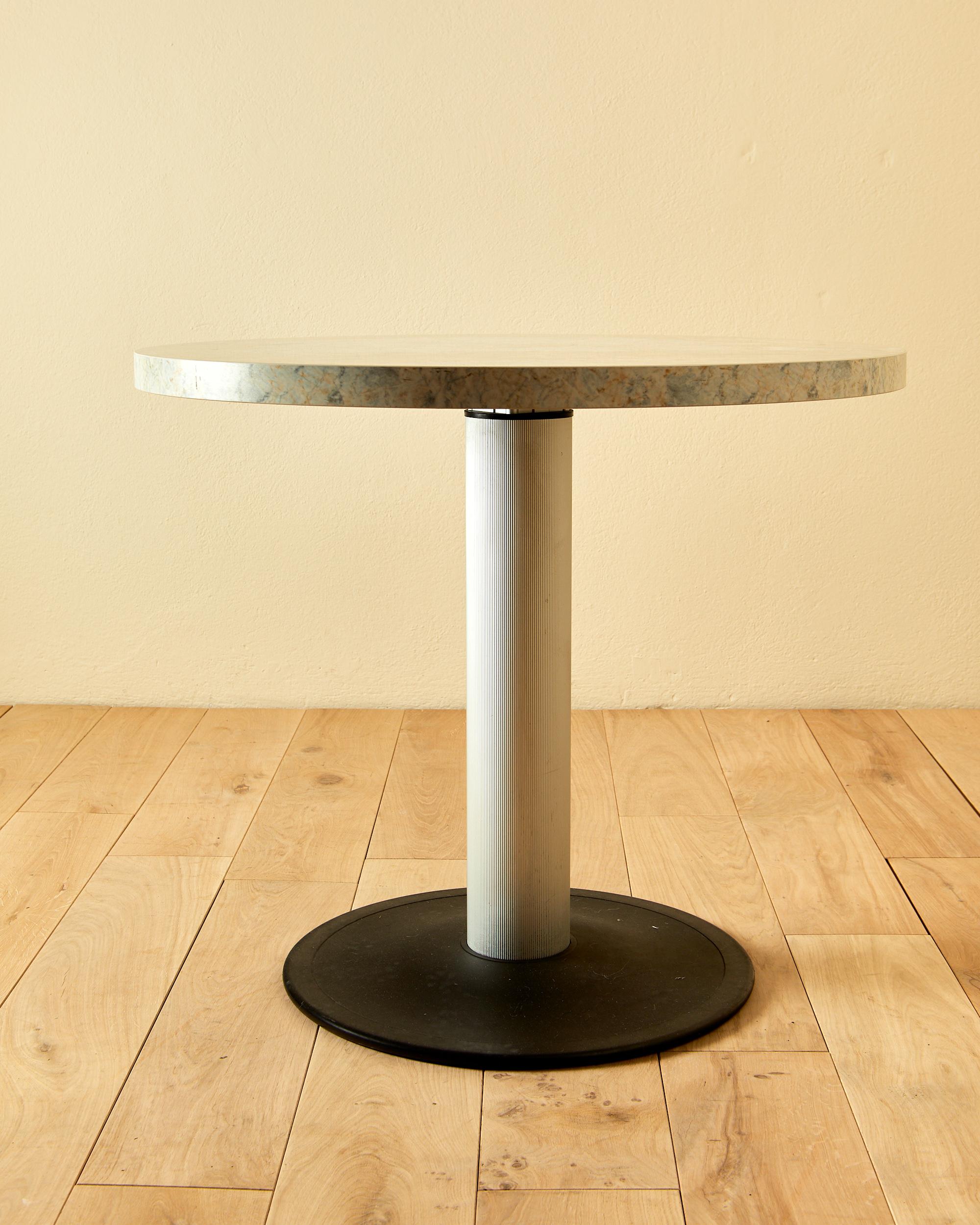 Memphis,
Pedestal table,
iron and aluminum base,
formica top in marble imitation,
circa 1980, Italy.
Height 74 cm, diameter 85 cm, depth of the top 4 cm.
