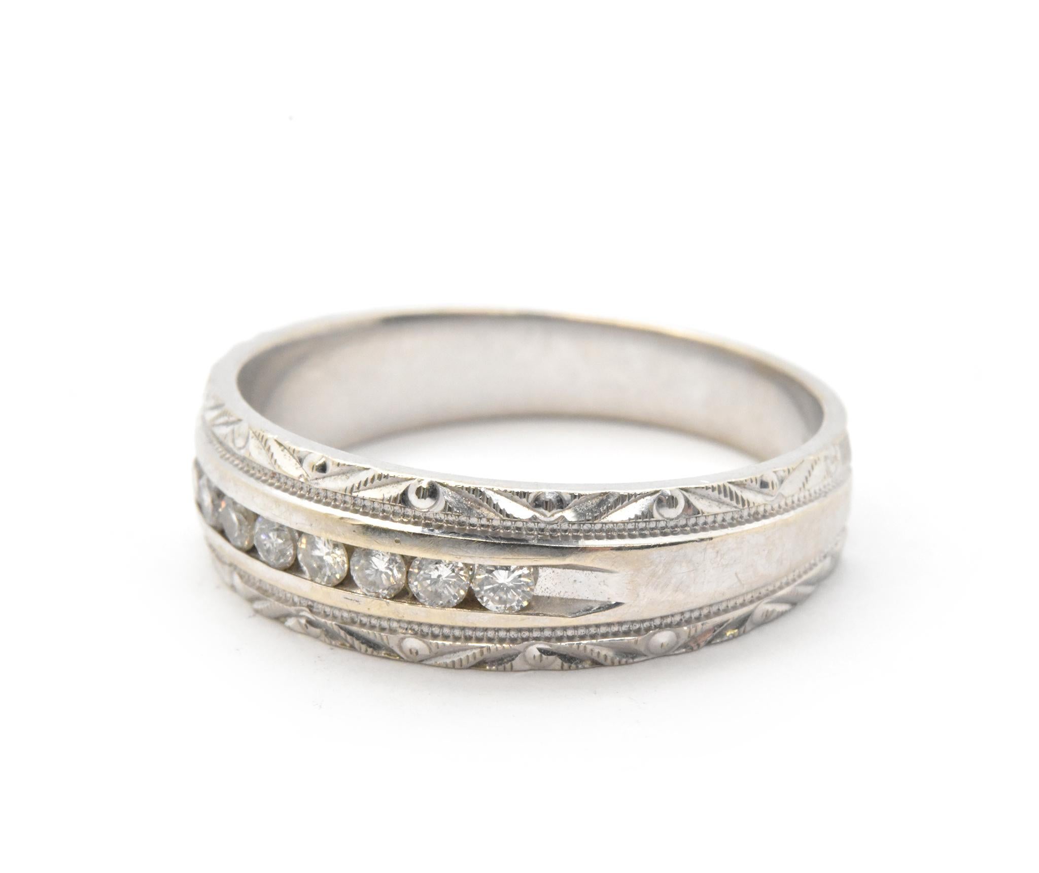 This men’s wedding band is crafted in 10 karat white gold and set with 8 round diamond melee equaling 0.24tw with H-I color and SI clarity. This band is 6.5mm wide with the diamonds channel set down the center and engraved accented edges in finger