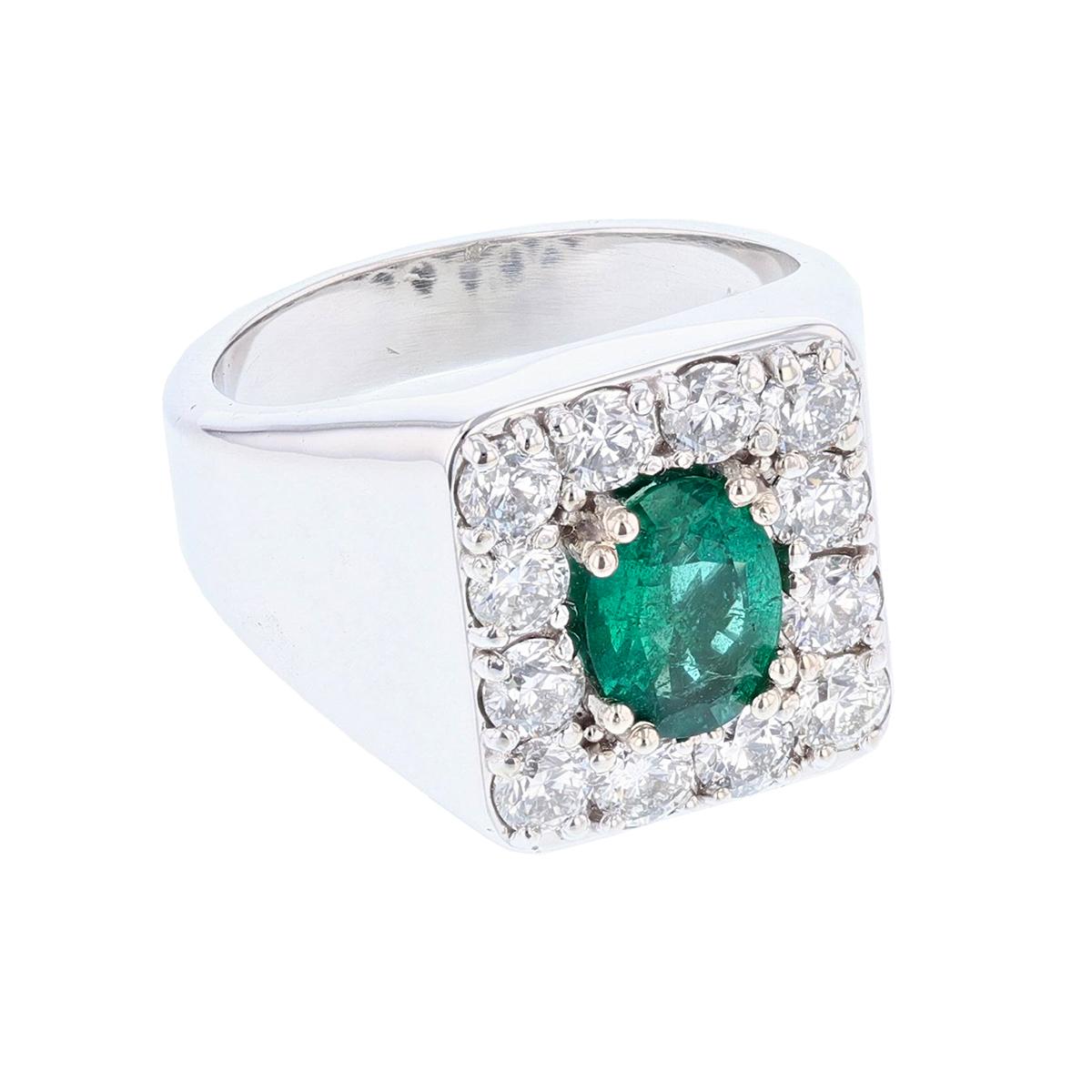 This gent's ring is made in 14 karat white gold featuring one oval cut Emerald weighing 1.44 ct that is prong set. The certificate number is GIA 2205469285. The ring features 12 round cut diamonds, prong set weighing 2.27cts with a color grade (H)
