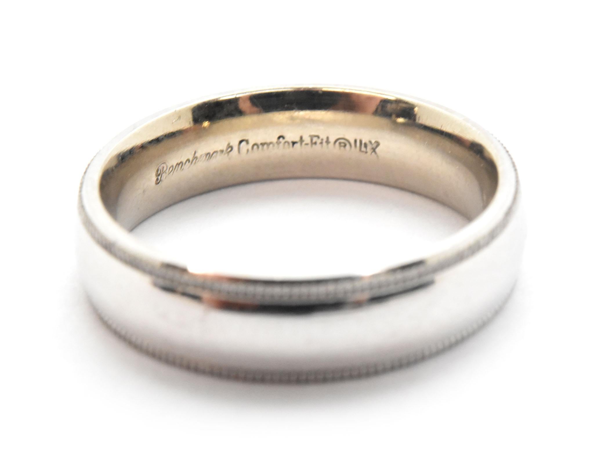 This classic band is crafted in 14k white gold with a high polished finish. Band on this ring is 5mm wide and 2mm thick. The size of the band is 6 and this ring weighs 5.55 grams.