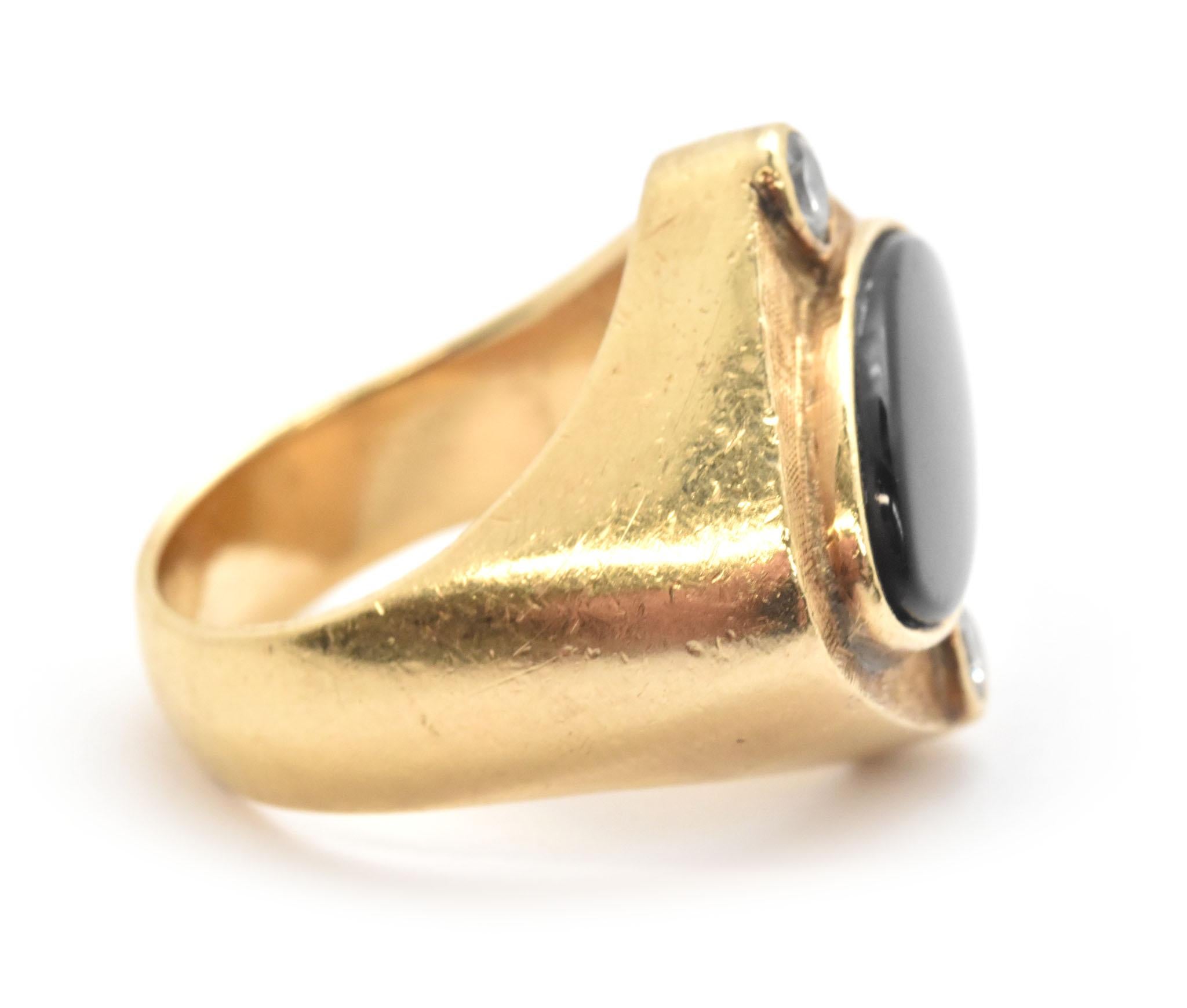 This ring is special, it is designed with 14k yellow gold. It is set with 2 round brilliant cut diamonds, and also a cabochon cut black onyx. The center gemstone is a cabochon black onyx it measures 20mm wide and 10mm tall. The diamonds on the ring