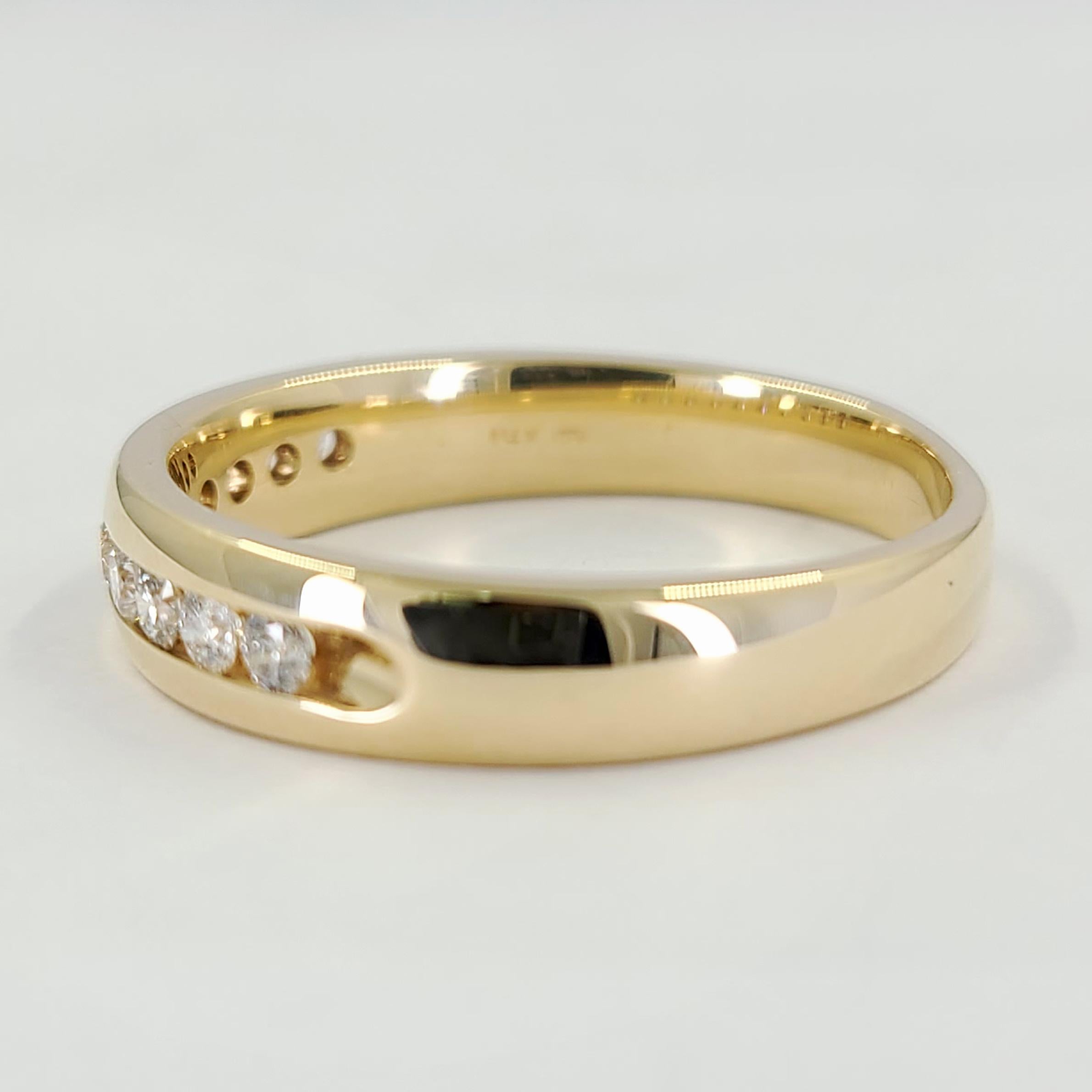 14 Karat Yellow Gold Men's Channel-Set Band Featuring 10 Round Brilliant Cut Diamonds Of SI Clarity & H Color Totaling 0.50 Carats. Finger Size 11; Purchase Includes One Sizing Service. Finished Weight Is 6.0 Grams.