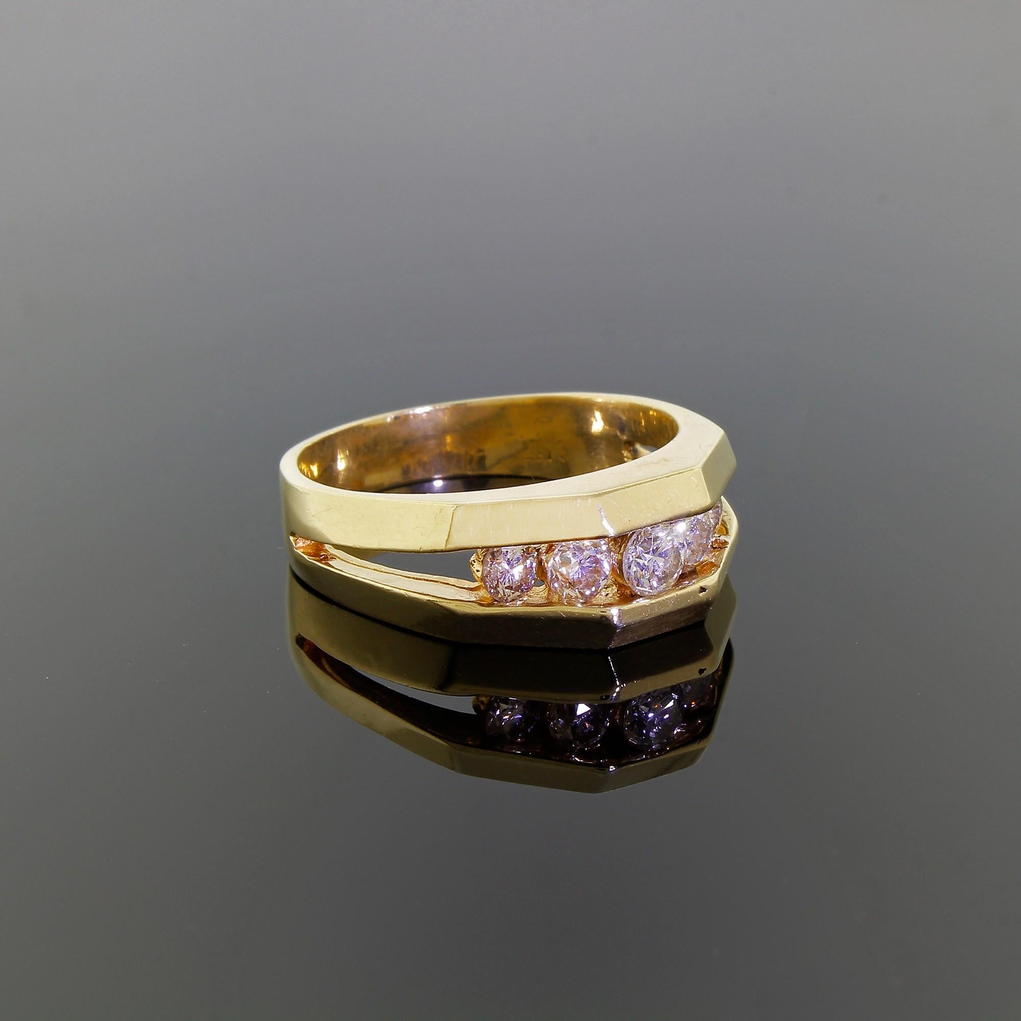 This vintage men's 14K yellow gold ring features a unique channel setting with five beautiful, sparkling diamonds that project slightly outwards from the finger when worn. This interesting design allows large quantities of light to pass through the