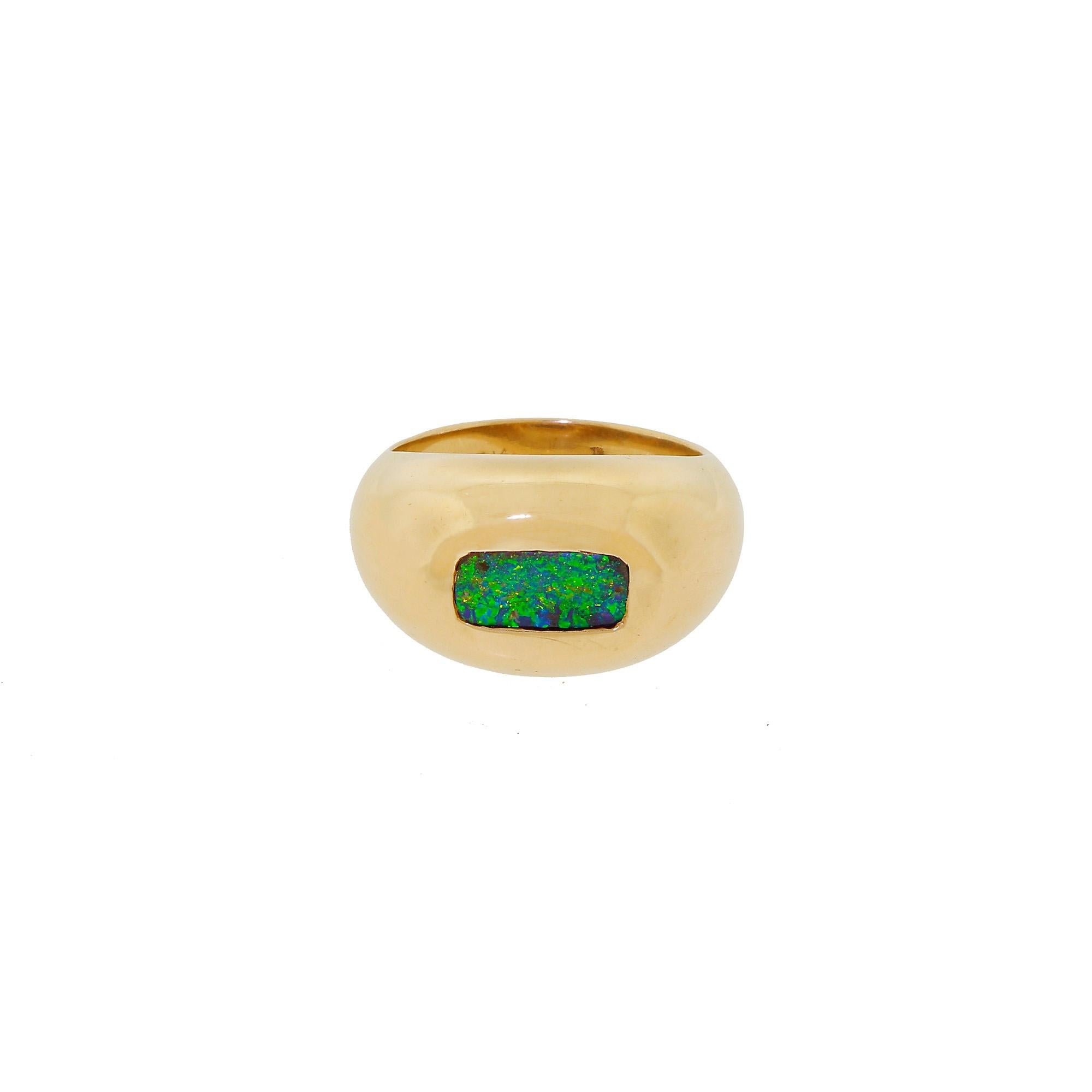 This bold men's Australian black opal ring from the 1960's is very much a conversation piece. Features a dense and well-crafted band made out of 14K yellow gold and it is an a USA size 8.75  - In the center lies the slip of Australian Black Opal