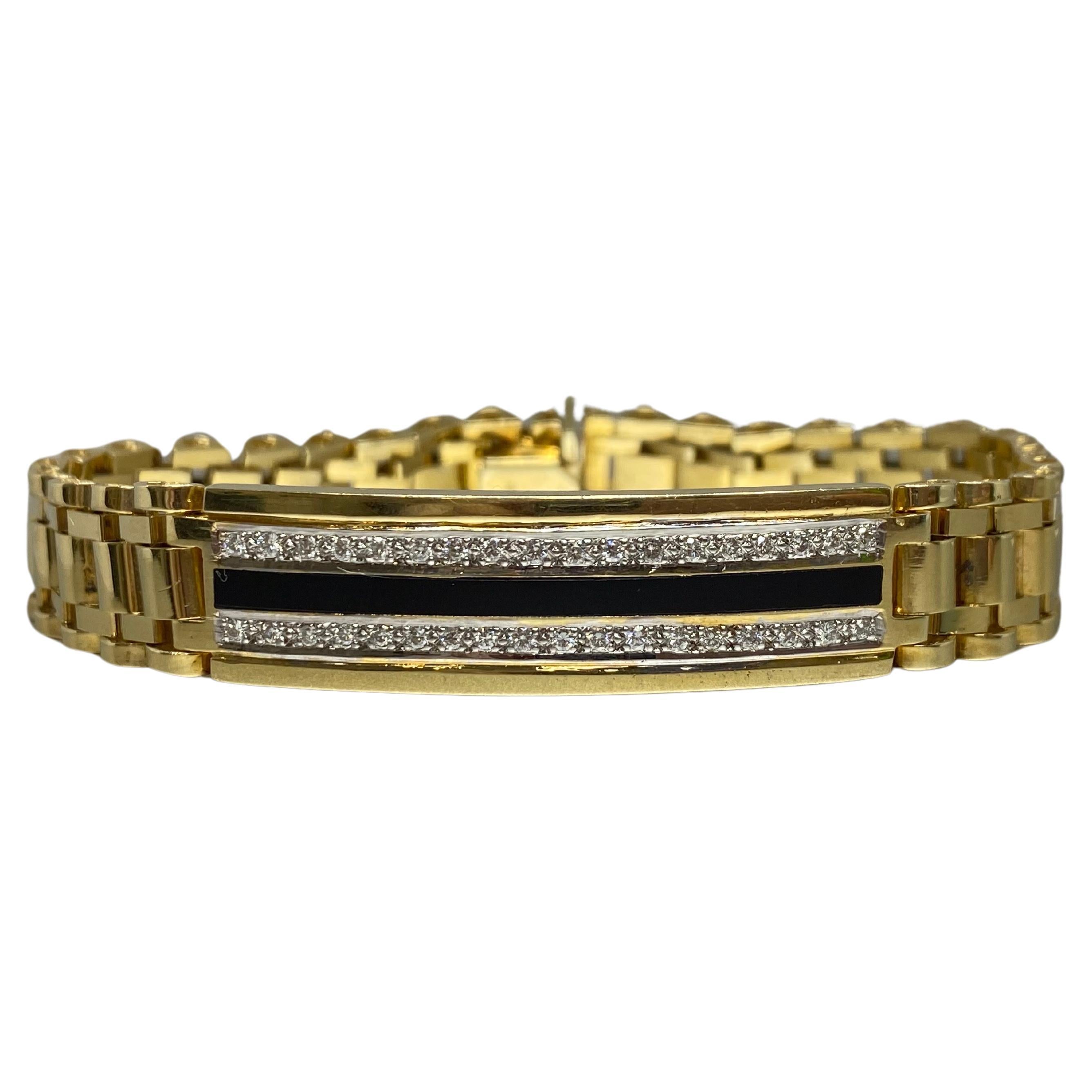 This is an eye-catching men's or unisex bracelet, crafted from 14k yellow gold with the popular jubilee design band in a polished finish. The front of the bracelet has a long curved bar decorated with a row of round brilliant cut diamonds  on either