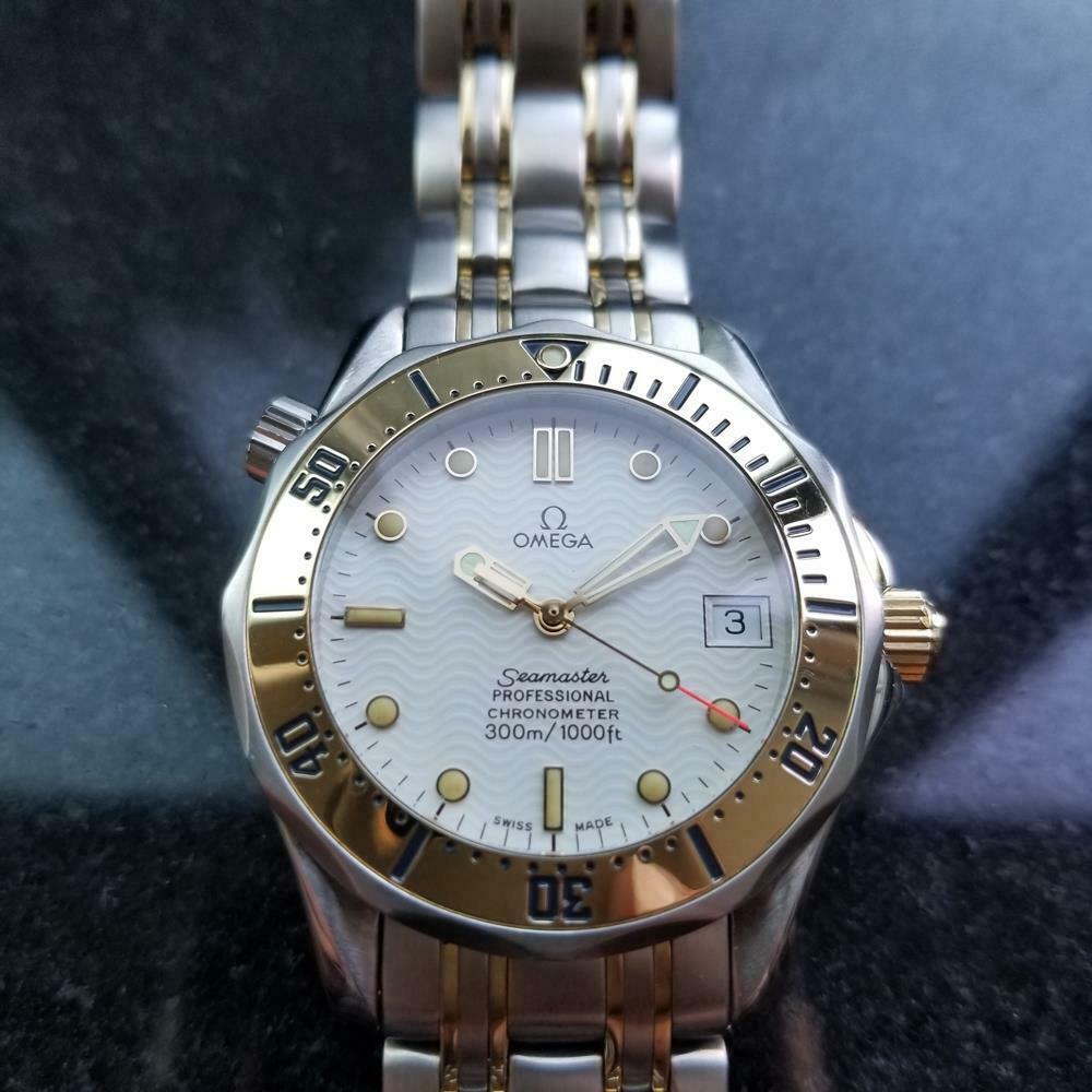 Sporty luxury, men's 18k gold and stainless steel Omega Seamaster Professional 300m automatic w/date, c.1986, all original. Verified authentic by a master watchmaker. Gorgeous white Omega wave dial, applied lumed droplet and bar hour markers, gold