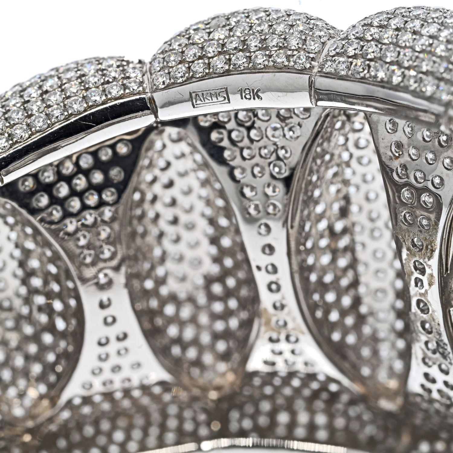 Impressive diamond cuff bangle made with round cut diamonds paved all over the cuff's surface. Made in 18K White Gold mounted with 85.00cttw of round cut diamonds. 
Wrist circumfrernce 7 inches.
Bangle Width: 4cm tapering to 2.5cm. 
Diamond Quality: