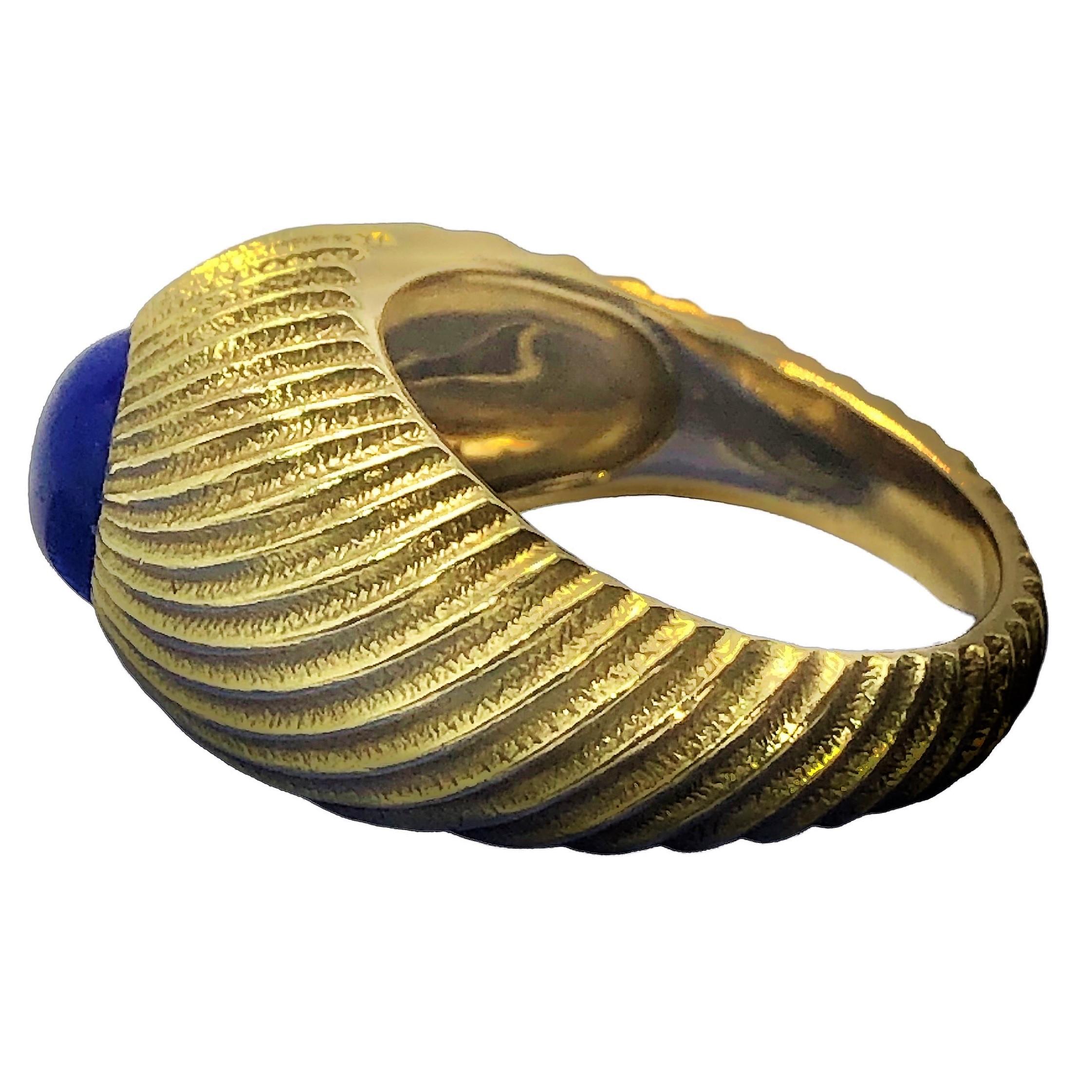 This elegant men's 18k yellow gold Tiffany & Co. Schlumberger dome ring is a graceful swirl of richly textured gold, terminating at the top in an 8mm round, rich blue Lapis-lazuli cabochon. Inside the ring a plate bears the name Tiffany & Co.