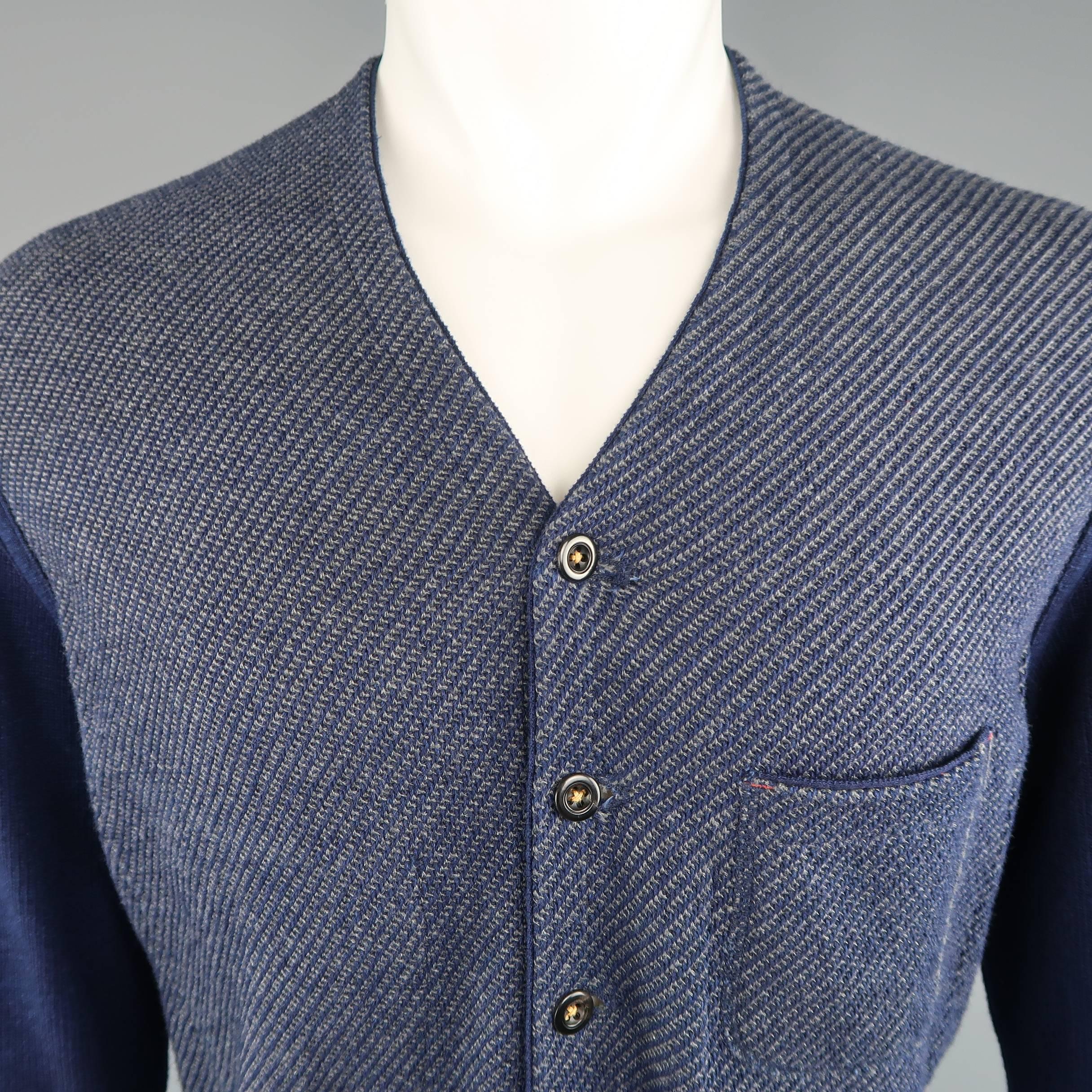 45rpm cardigan comes in navy blue cotton nit with grey textured mid section, v neck, button up front, and patch pockets. Made in Japan.
 
Excellent Pre-Owned Condition.
Marked: JP 5
 
Measurements:
 
Shoulder:18 in.
Chest: 46 in.
Sleeve: 25