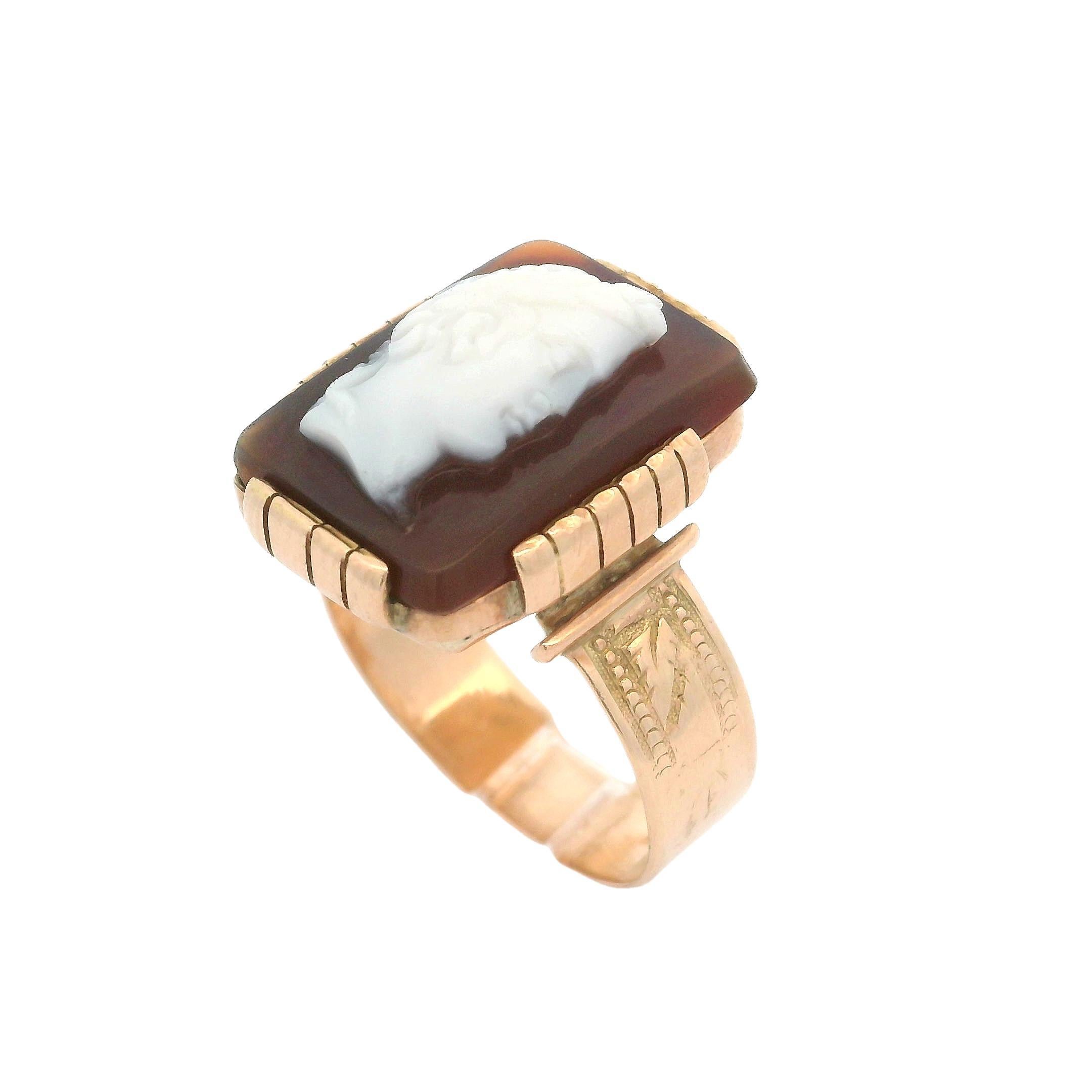 –Stone(s)–
(1) Genuine Hardstone - Rectangular Carved Cameo - Prong Set - Reddish Brown Base Color w/ White Carving - 17.30 x 12.6mm (approx.)

Material: 14k Rosy Yellow Gold
Weight: 6.98 Grams
Ring Size: 9.5 ( fitted on finger, please contact us