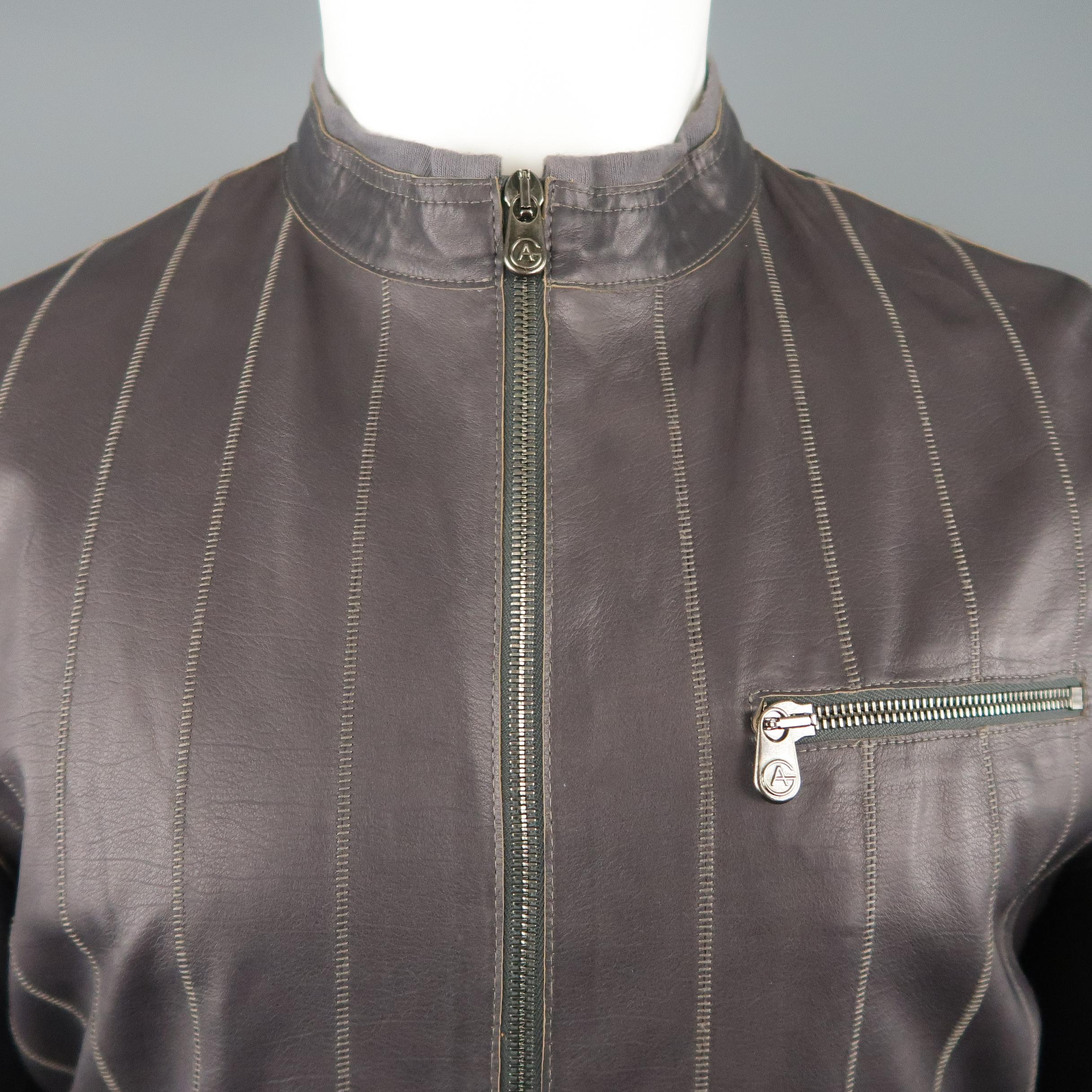 ARMANI COLLEZIONI motorcycle style jacket comes in muted eggplant purple leather with stitched stripe pattern, band collar with knit trim, zip cuffs, and zip pockets.
 
Excellent Pre-Owned Condition.
Marked: 40
 
Measurements:
 
Shoulder: 18