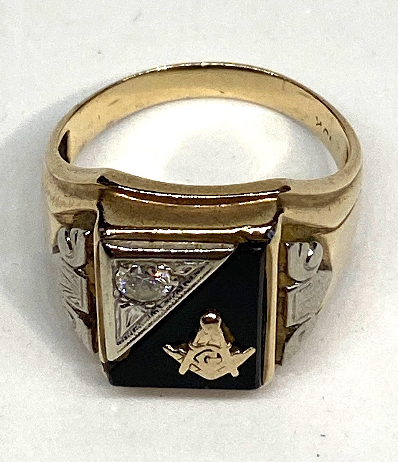 A vintage Art Deco mens Mason ring circa 1940. It is 10 karat yellow and white gold, black onyx and genuine diamond. The diamond is approximately a third of a carat and it is mounted into a etched triangle of white gold. Two more white gold