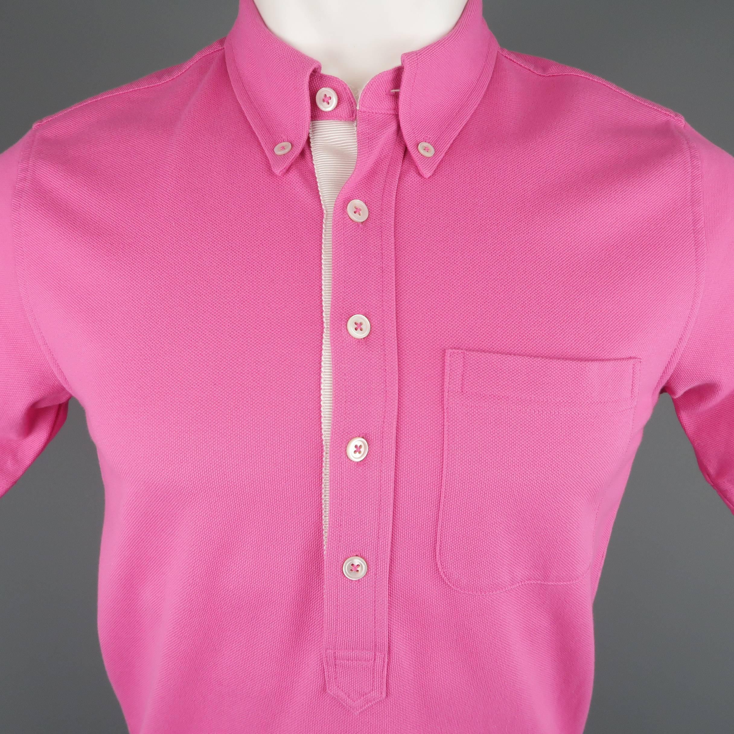 BLACK FLEECE  polo comes in dark pink cotton pique with a pointed button down collar cream ribbon trim, and patch pocket.
 
Excellent Pre-Owned Condition.
Marked: BB1
 
Measurements:
 
Shoulder: 15 in.
Chest: 36 in.
Sleeve: 9 in.
Length: 26 in.
