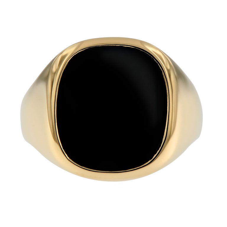 Men's classic signet ring features a black onyx center stone and crafted in 18k yellow gold. This estate piece is in good condition with normal wear. Top of ring measures 17mm x 17.5mm. Weighs 15.3 grams. Ring size 10.75.