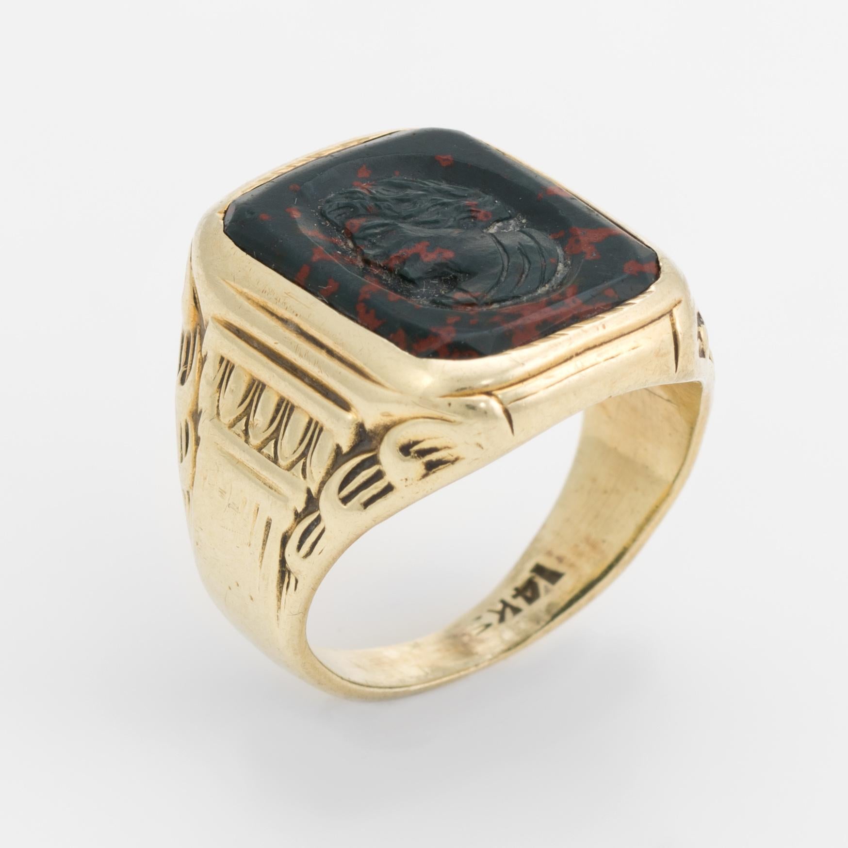Finely detailed vintage Art Deco era ring (circa 1920s to 1930s), crafted in 14 karat yellow gold. 

Bloodstone measures 16mm x 12mm and features a carved bust of a man. The bloodstone is in very good condition with a few nicks visible under a 10x
