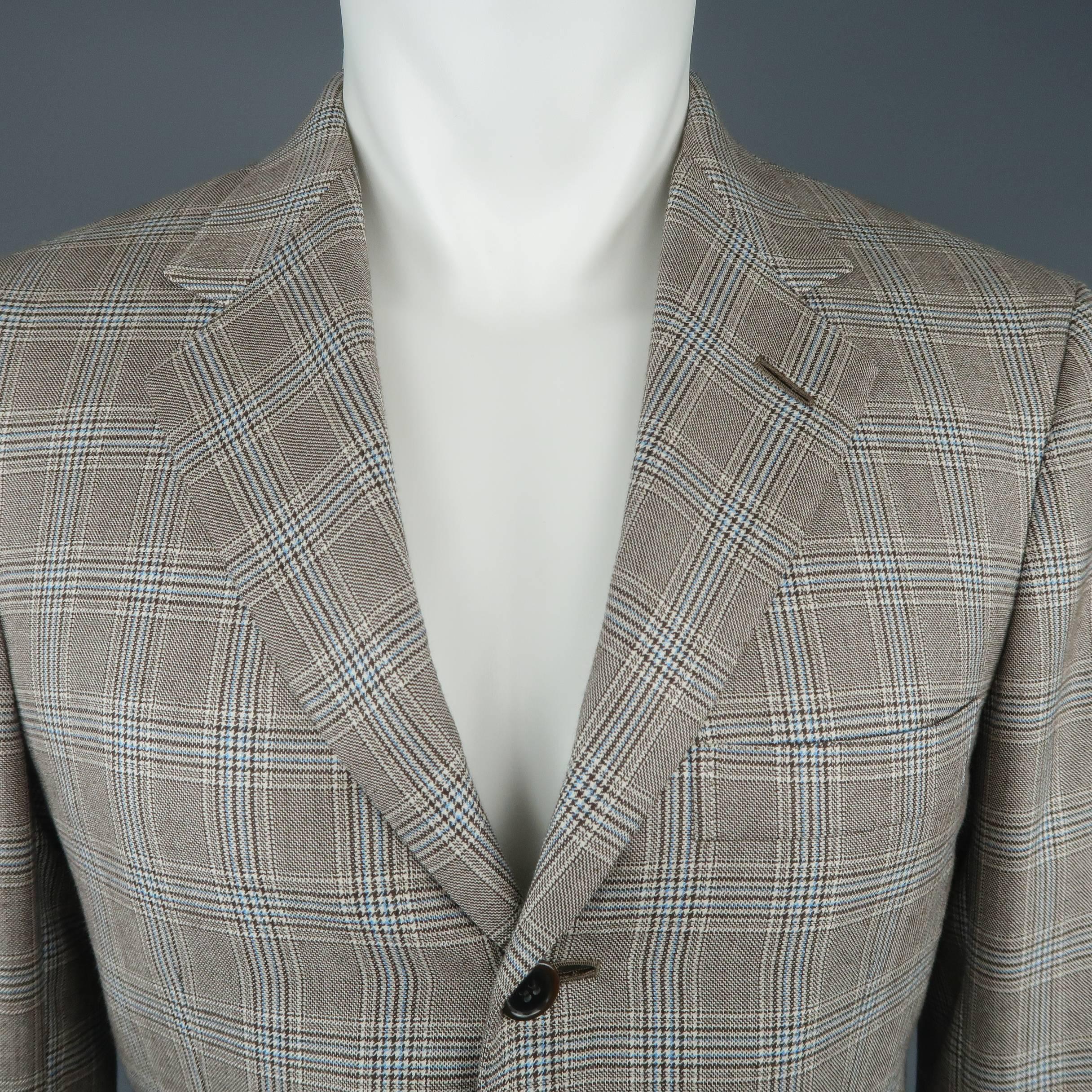 Vintage BRIONI single breasted sport coat comes in beige and brown glenplaid wool silk blend with light blue accents, three button front, notch lapel, and functional button cuff. Made in Italy.
 
Excellent Pre-Owned Condition.
Marked: 38