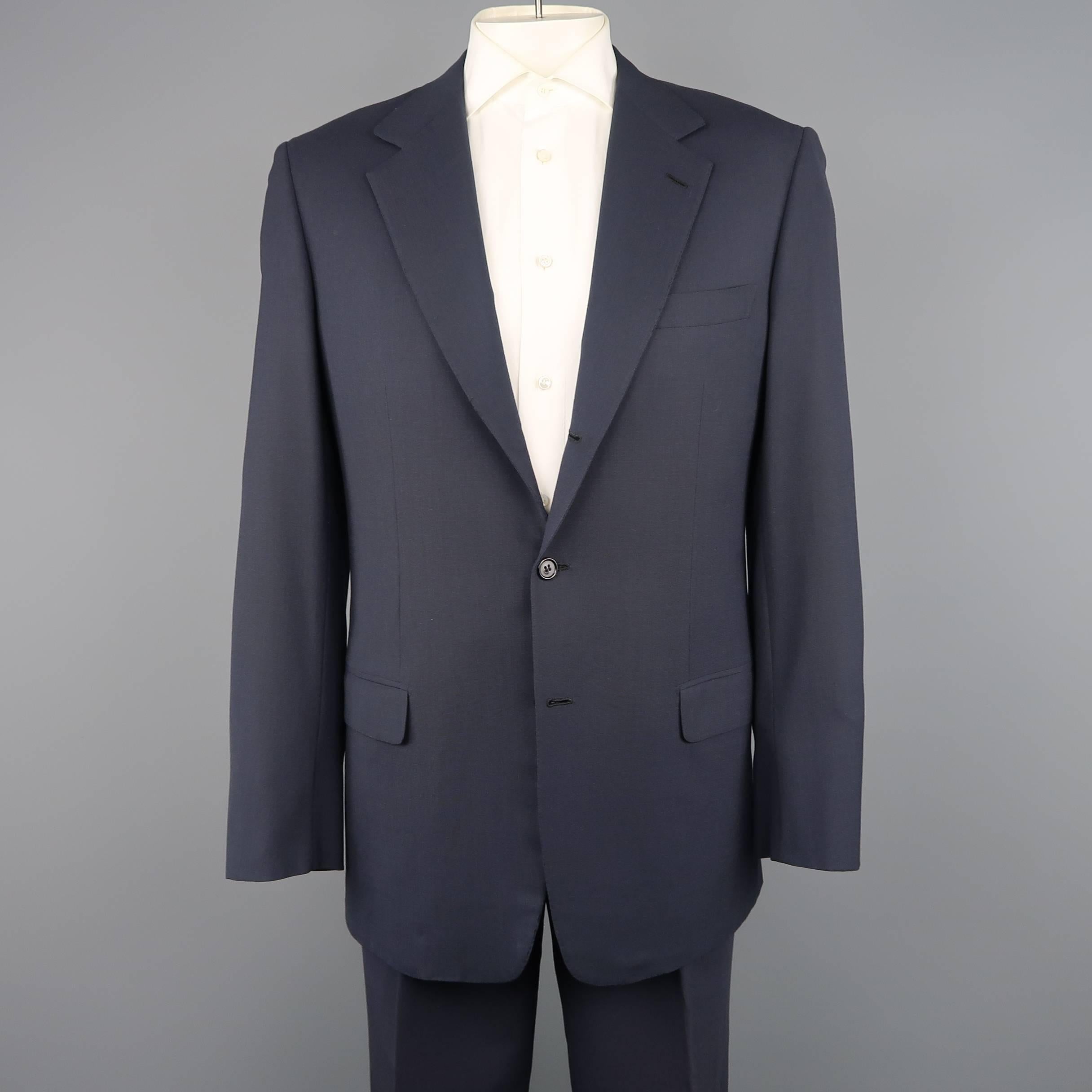 Vintage two piece BRIONI-NOMENTANO suit comes in woven navy blue wool and includes a single breasted, three button sport coat with notch lapel and functional button cuffs and matching pleated, cuffed hem trousers. Made in Italy.
 
Good Pre-Owned