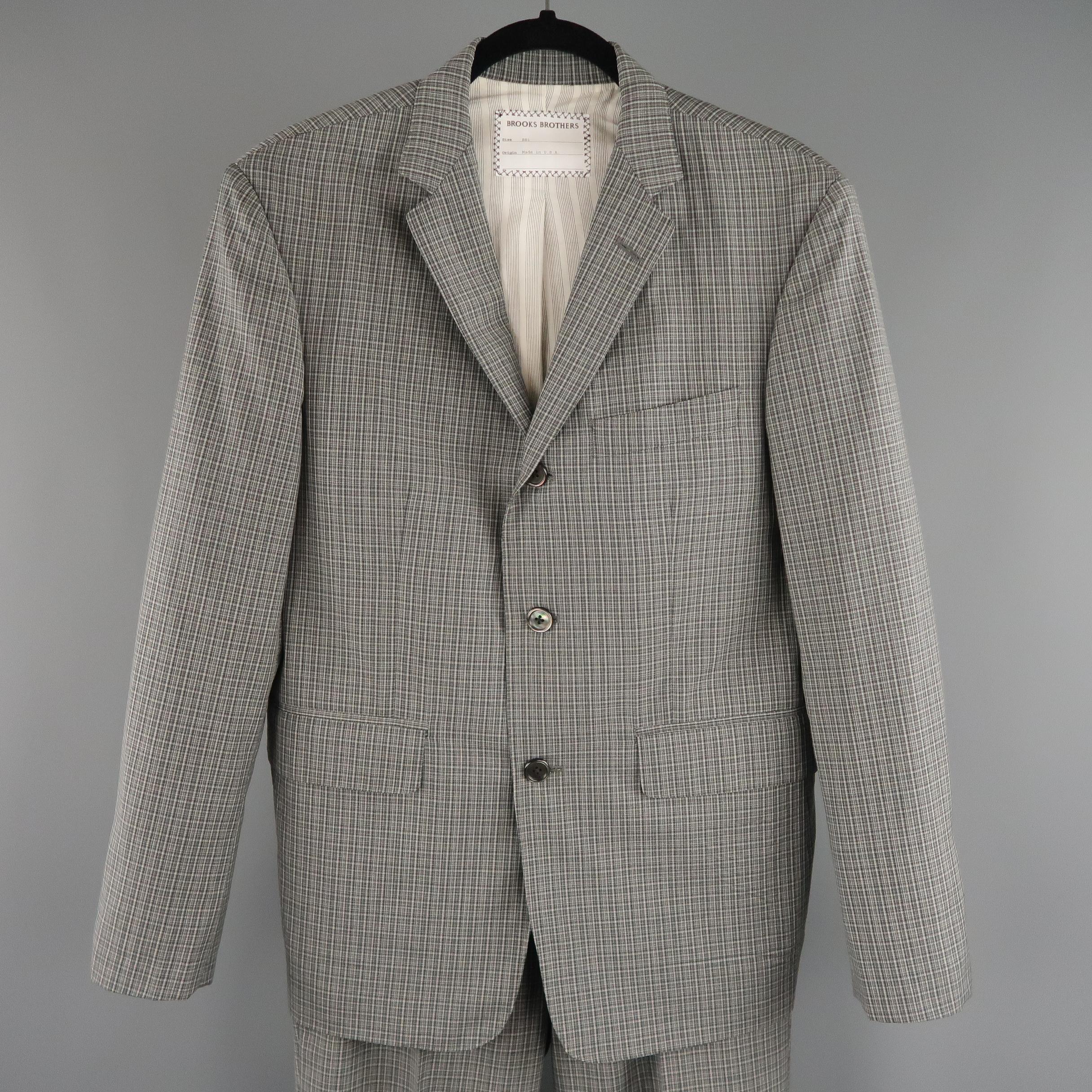 This two piece BROOKS BROTHERS suit comes in dark gray plaid wool  and includes a single breasted, three button sport coat with notch lapel and matching flat front, cuffed trousers. Made in USA.
 
Excellent Pre-Owned Condition.
Marked: BB1
