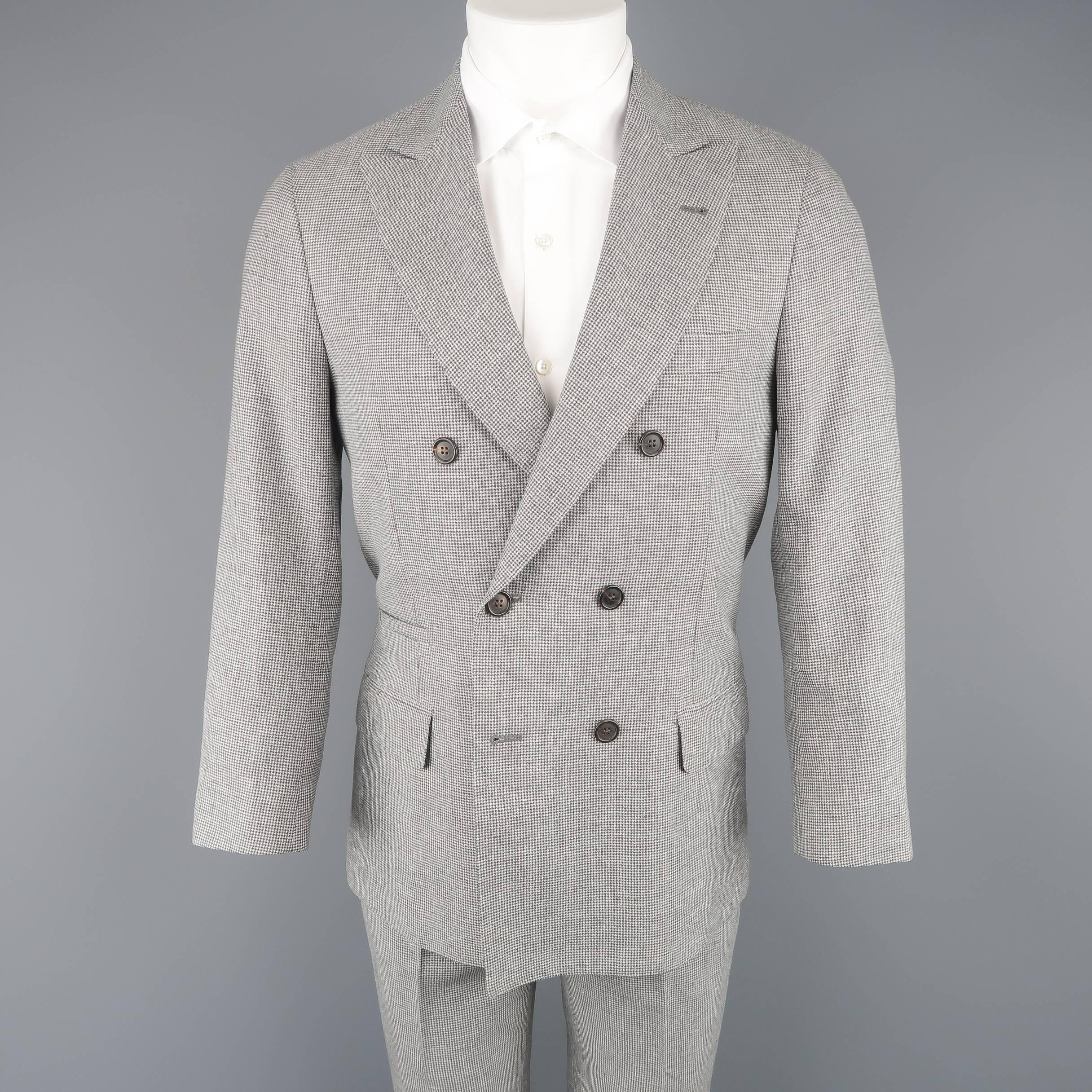 Two piece BRUNELLO CUCINELLI suit comes in a black and white houndstooth print linen, wool, and silk blend fabric and includes a double breasted, peak lapel sport coat with functional button cuffs and matching cuffed  flat front trousers. Made in