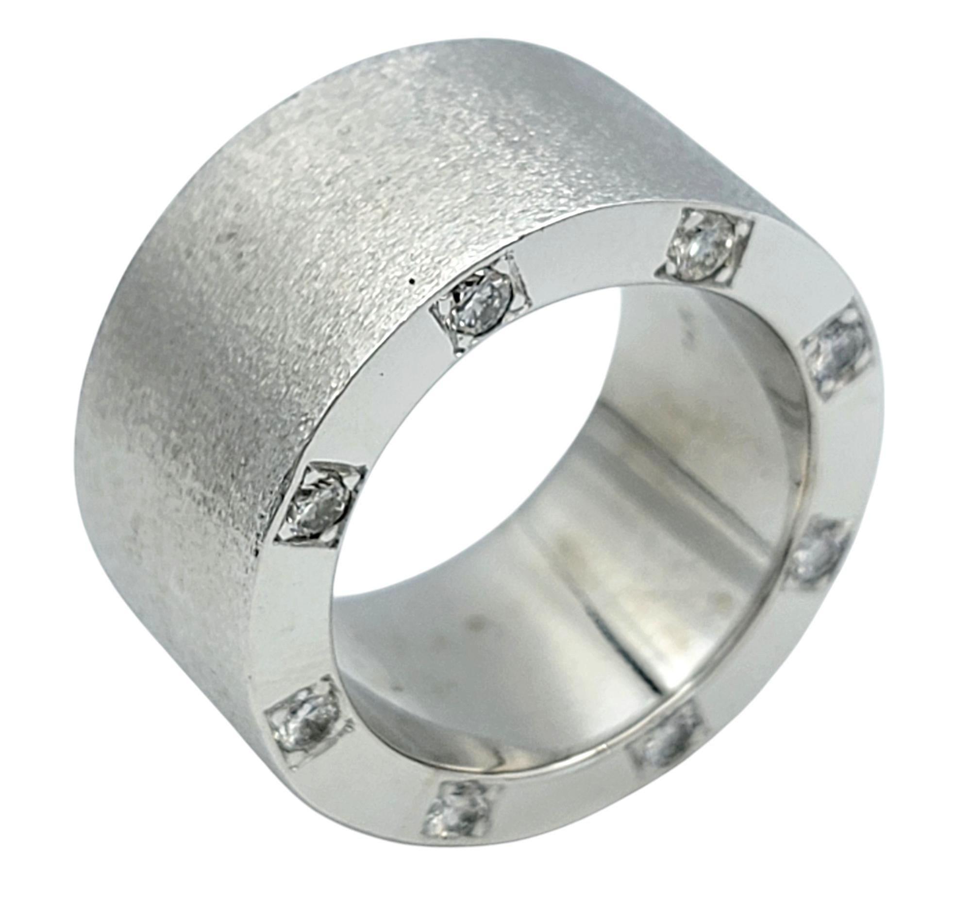 Size: 9 

This sophisticated men's diamond ring is a true testament to refined elegance. Crafted from lustrous 14 karat white gold, the wide brushed finish band features a clean, polished trim along it's edges that reflects light beautifully. The