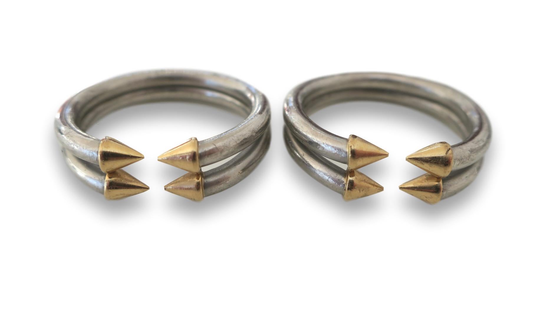Pair of 70's Rings by Bulgari. A pair of Platinum and 18k gold stacking rings , each with a double tubular design of solid platinum terminating in four 18k yellow gold pointed conical shapes. Reminiscent of arrows these weighty rings almost invoke