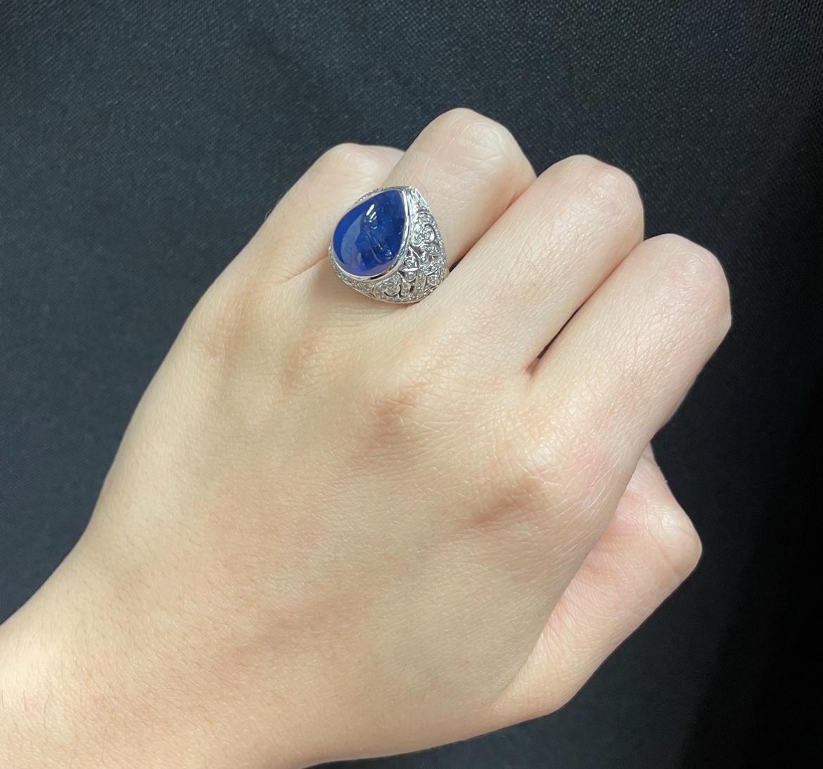 Men's Cabochon Sapphire Ring 

A white gold ring set with a tall cabochon sapphire accented by diamonds. 

Approximate Sapphire Weight: 11.30 carats
Approximate Diamond Weight: .90 carats 
Ring Size: 5.75
Resizable free of charge
Metal Type: