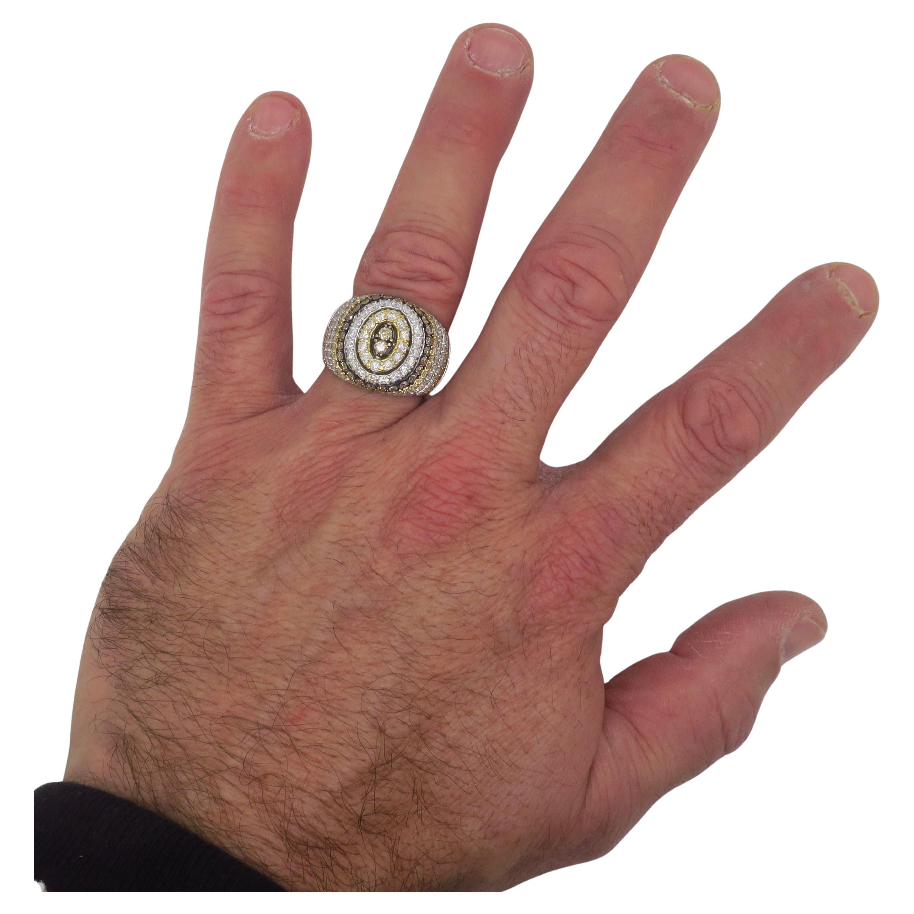 Impressive 4.68CTW Chocolate, Light Yellow & White diamond encrusted ring crafted in 14k white gold. 

Diamond Carat Weight: 4.68CTW
Diamond Cut: Round Brilliant Cut 
Color: Chocolate, Light Yellow, White (G-H)
Clarity: VS1-SI2
Metal: 14k White Gold
