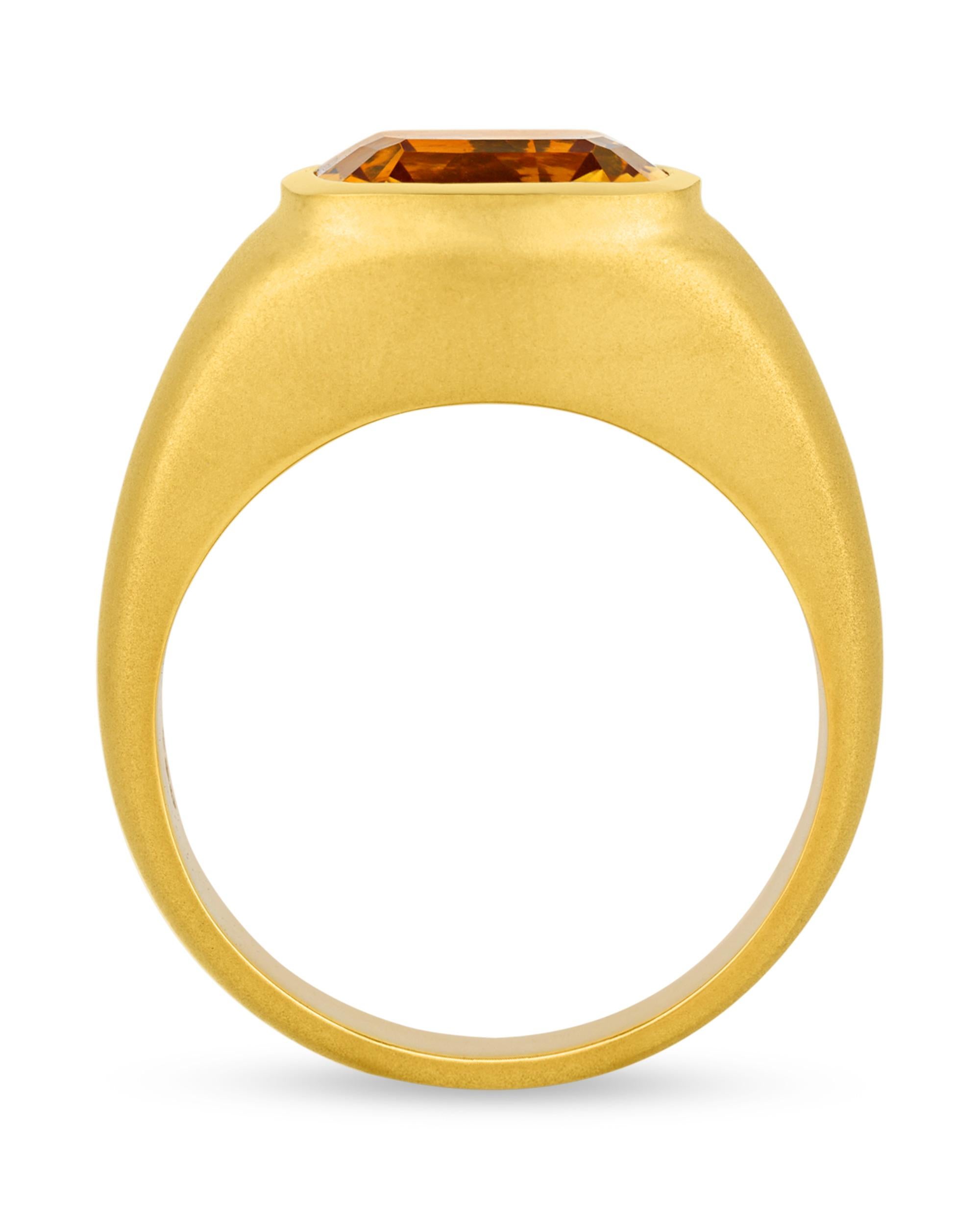 A sunny mixed-cut citrine weighing 6.10 carats centers this stylish men's ring. Exhibiting a warm yellow hue, this jewel is certified by the American Gemological Laboratories and set into a domed 18K yellow gold setting.