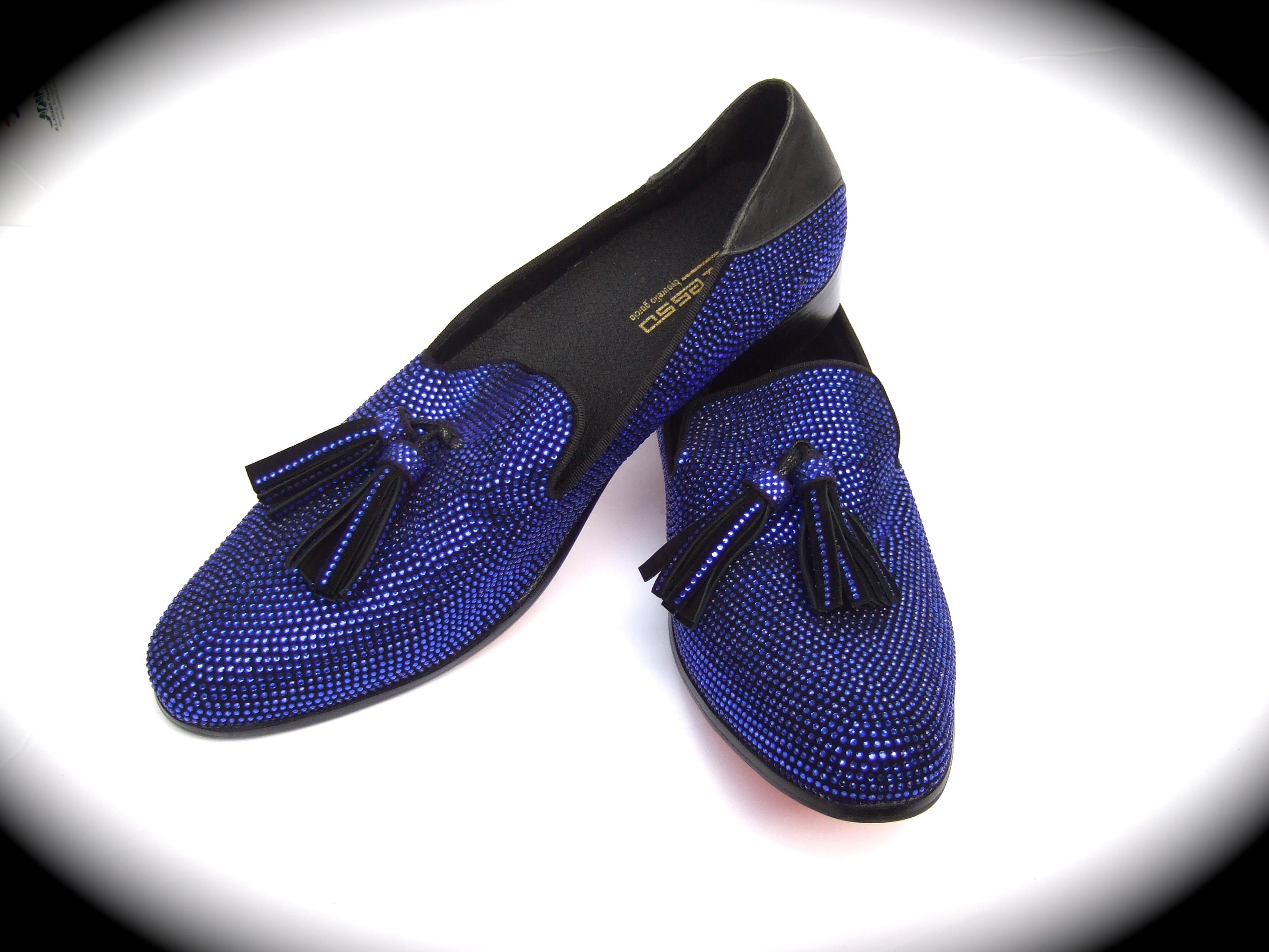 Men's cobalt blue jeweled crystal tassel slipper style dress shoes  Stamped Size 11
The stylish men's shoes are covered with contiguous cobalt blue
color crystals

Accented with a pair of tassels on the front of each shoe
The back of each shoe has a