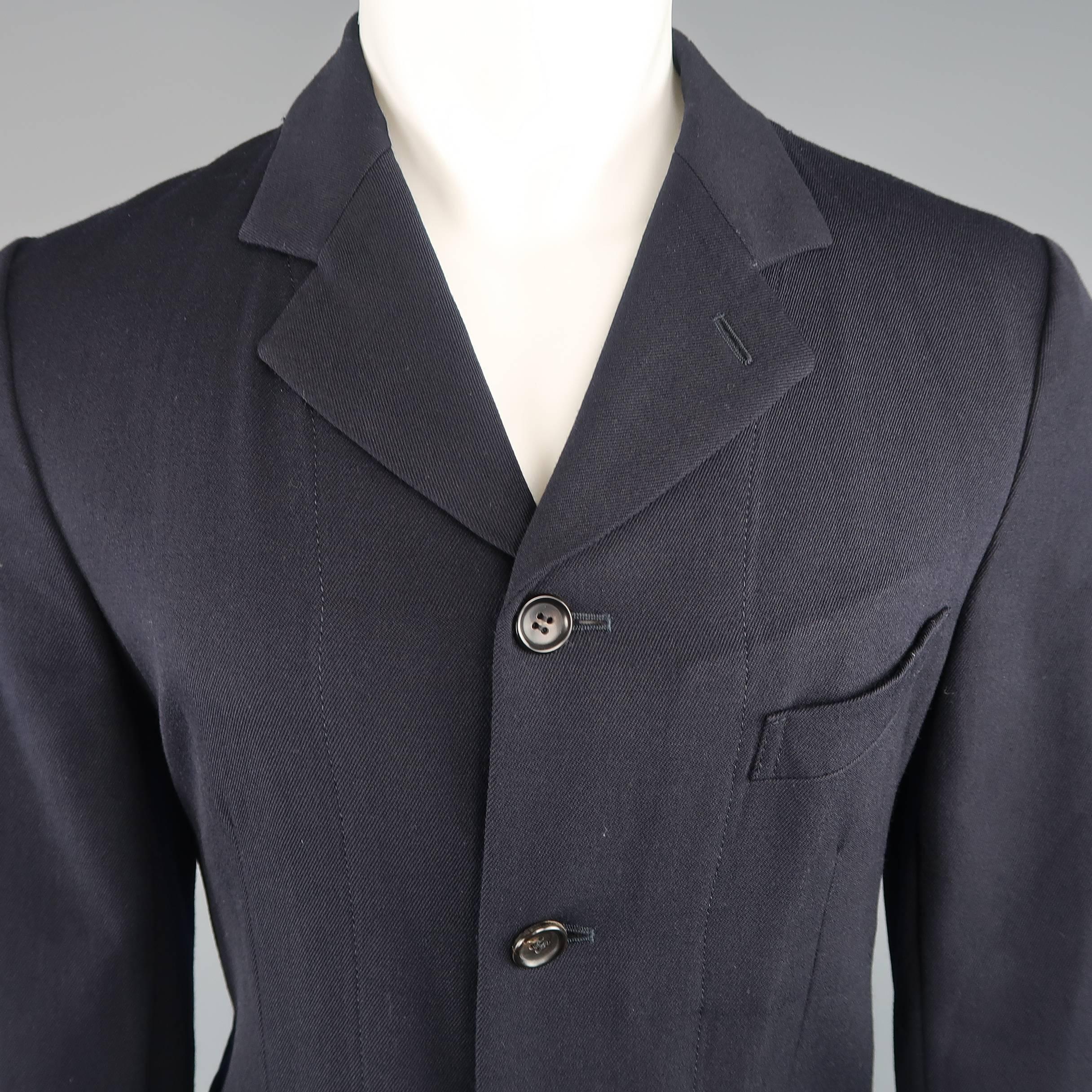 COMME des GARCONS HOMME PLUS EVERGREEN sport coat comes in navy blue wool twill with a notch lapel, four button front, and vertical seam details. Made in Japan.
 
Good Pre-Owned Condition.
Marked: M
 
Measurements:
 
Shoulder: 17 in.
Chest: 42