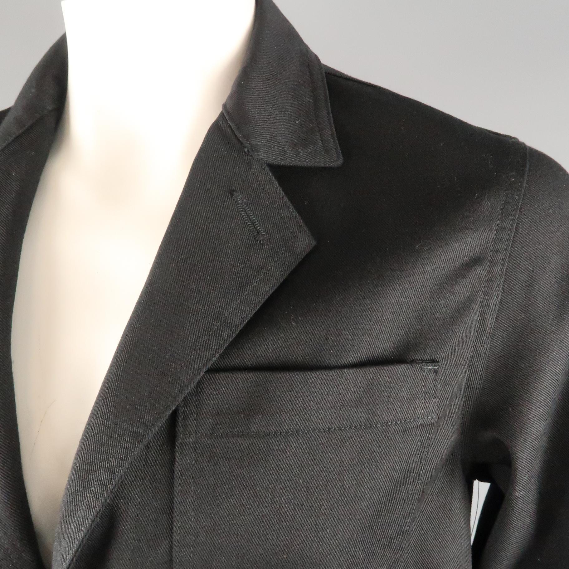COMME des GARCONS GANRYU sport coat jacket comes in black twill with a notch lapel, two button single breasted front, and work wear style patch pockets. Made in Japan.
 
Excellent Pre-Owned Condition.
Marked: L
 
Measurements:
 
Shoulder: 18