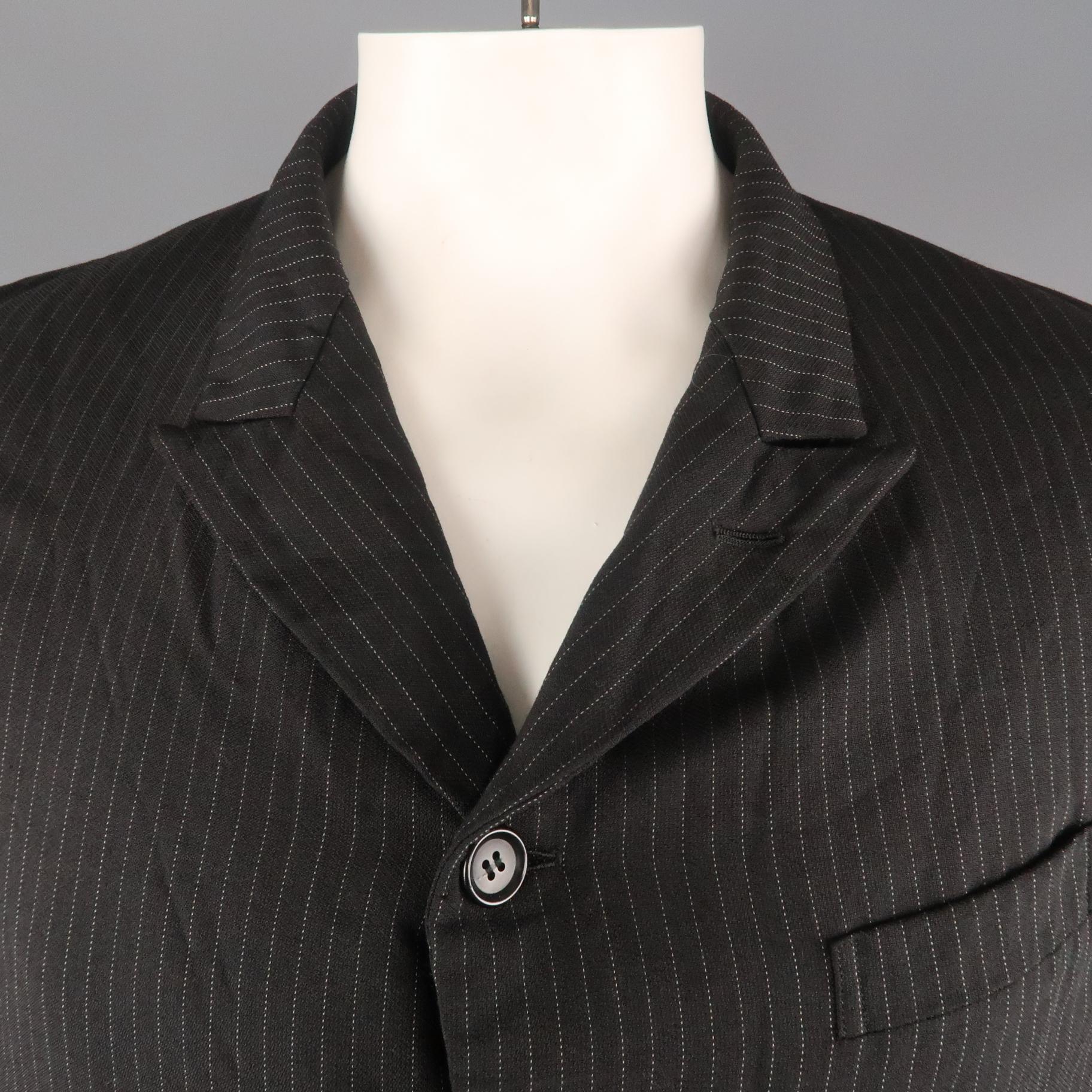 COMME des GARCONS HOMME DEUX sport jacket comes in black pinstripe wrinkle textured fabric with a peak lapel, single breasted four button front, flap pockets, and half liner. AD2017. Made in Japan.
 
Excellent Pre-Owned Condition.
Marked: L
