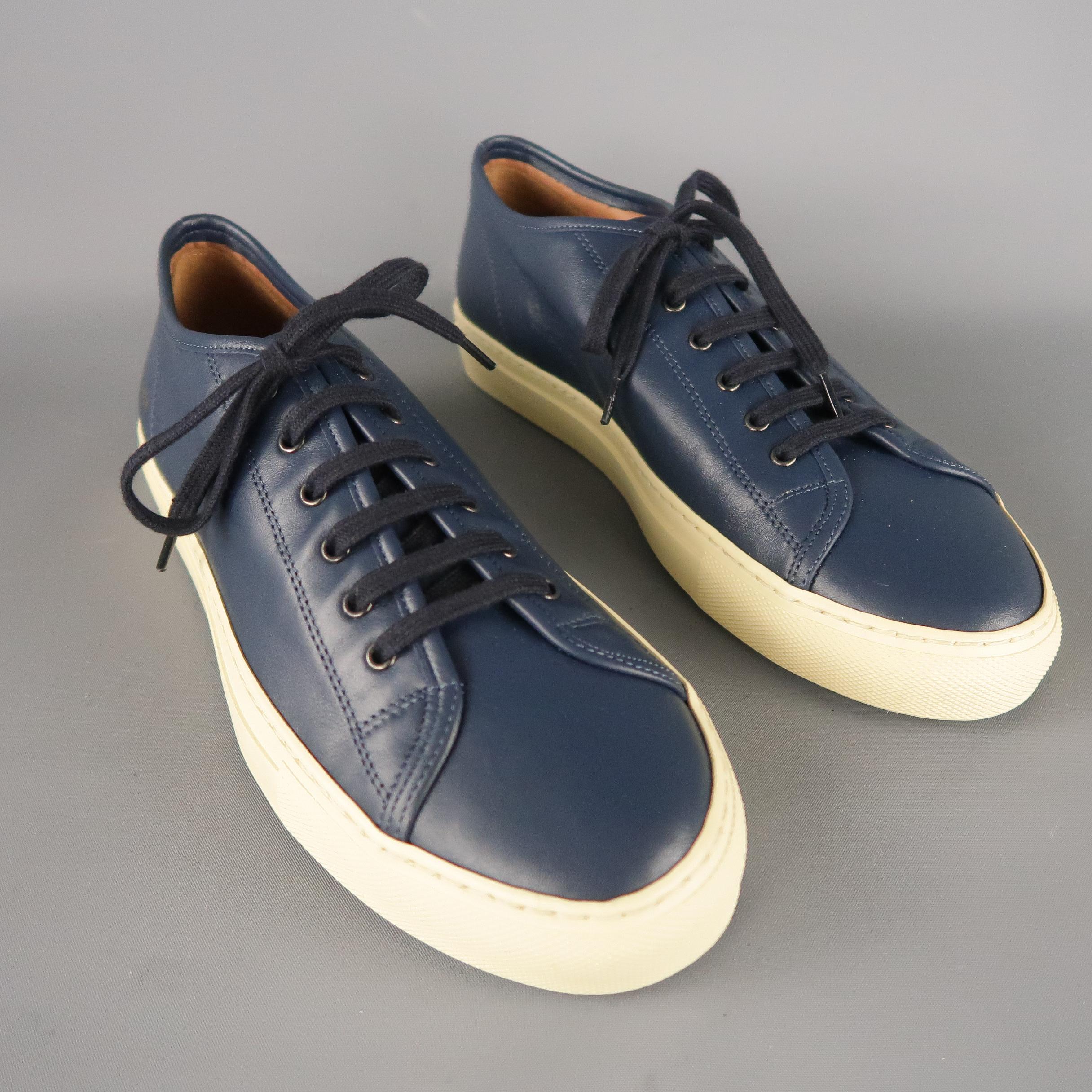 COMMON PROJECTS Achilles are navy solid leather low-top sneakers, accented with a gold metallic 