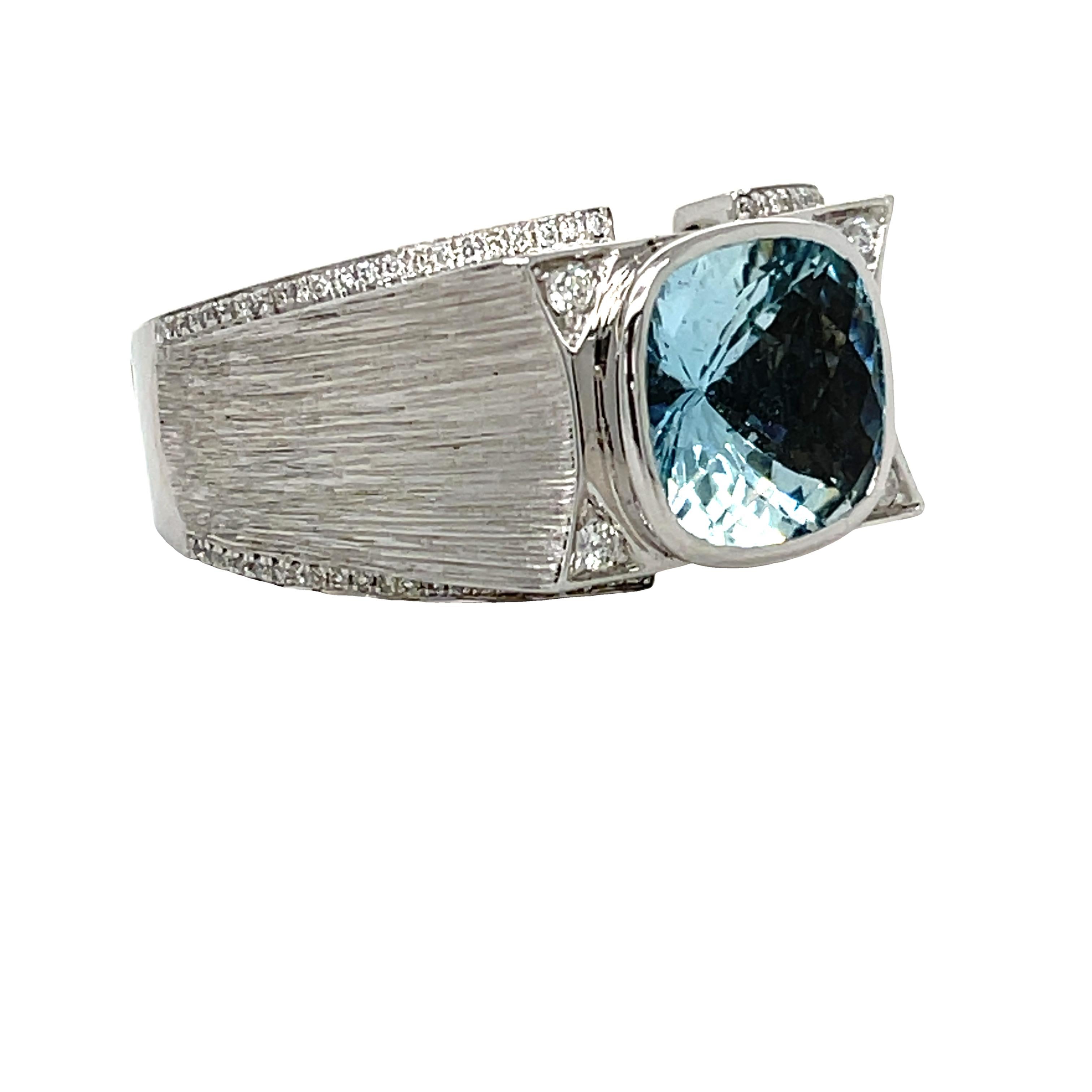 This unique Men's ring has a vibrant blue top quality cushion checkerboard Aquamarine center bezel set in 14K white gold. There are 88 brilliant cut diamonds on the shank. It comes in a beautiful box ready for the perfect gift!

14KW:           