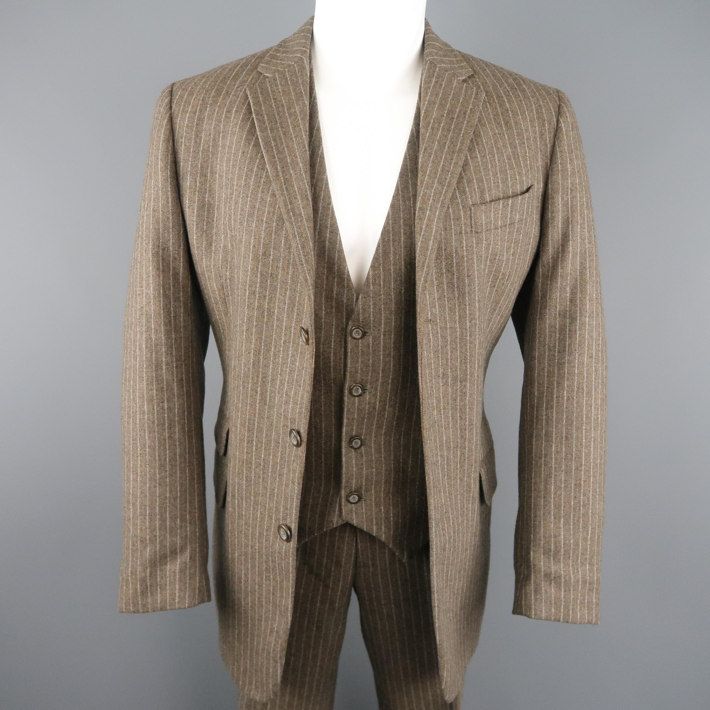 D&G by DOLCE & GABBANA suit comes in taupe brown striped wool blend fabric and includes a single breasted, three button, notch lapel jacket, v neck vest with floral back, and matching cuffed trousers. Made in Italy.
 
Excellent Pre-Owned