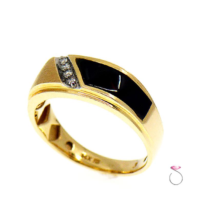 This very elegant Men's Diamond & Black Onyx Ring in 14K yellow gold is a real classic. The ring has a large tapered rectangular black Onyx stone on one side and four high quality brilliant round diamonds bead set in a channel. The diamonds are G
