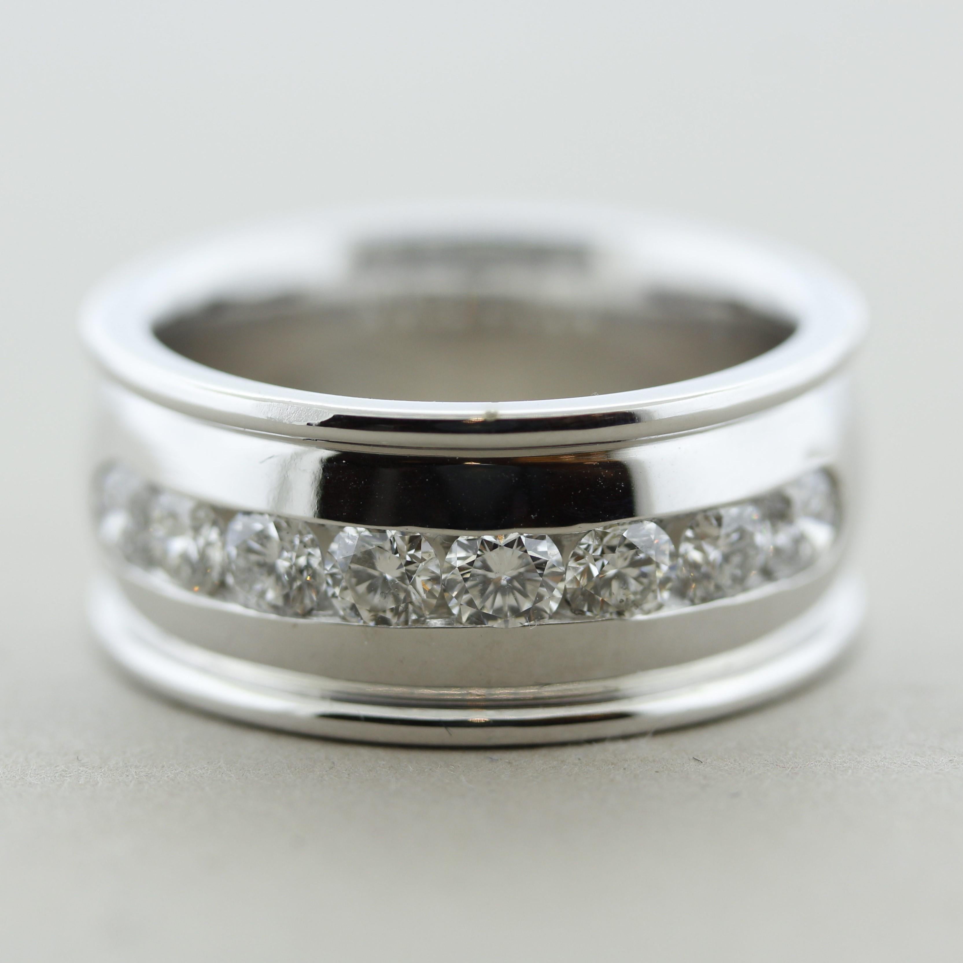 A large white gold band featuring 8 round brilliant-cut diamonds weighing a total of 1.40 carats. They are white bright and clean, channel set in the center of the ring. Made in 14k white gold and ready to be worn.

Ring Size 11.25