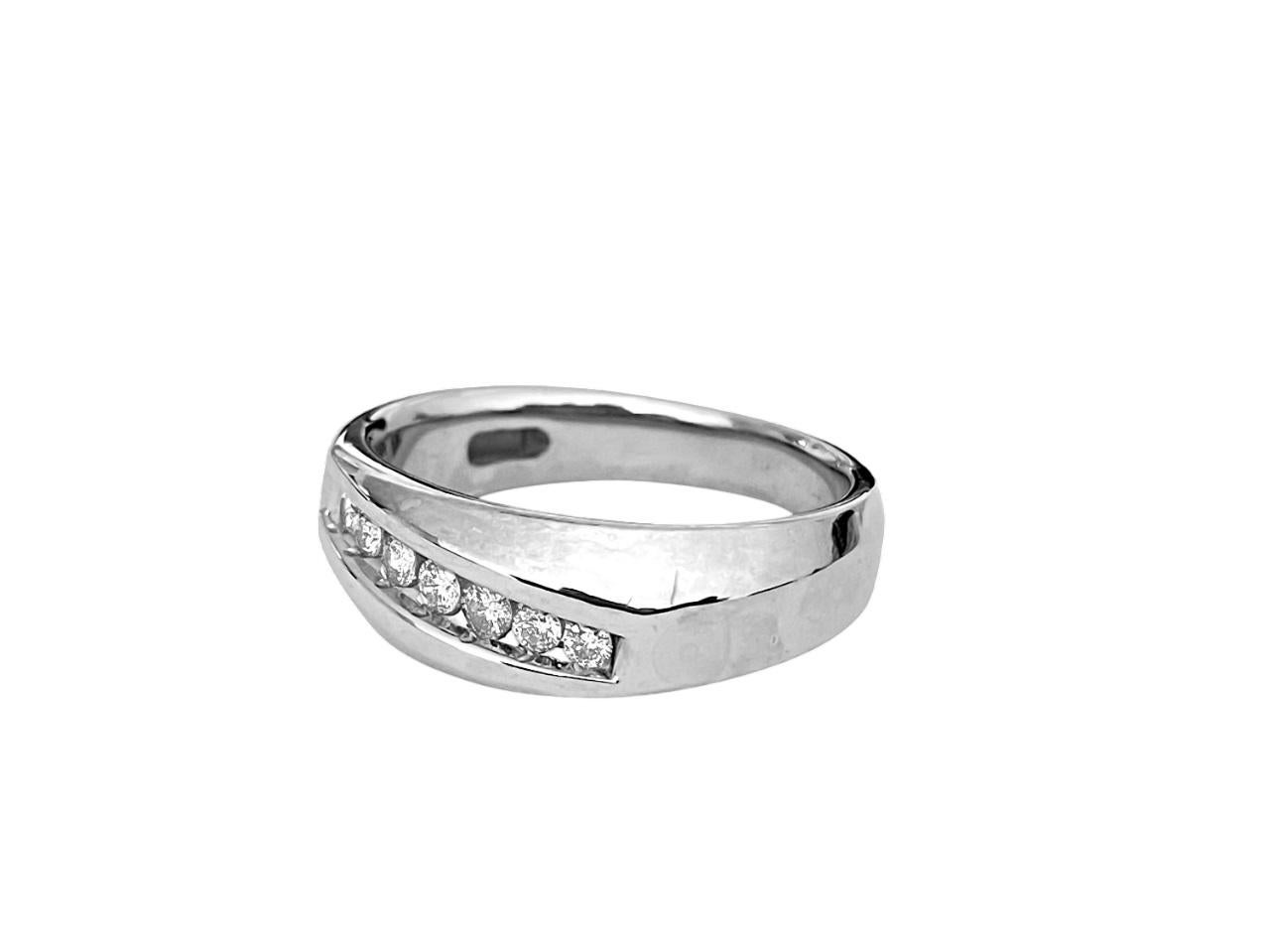 Fashioned from 14k white gold, this exquisite men's wedding band features a total diamond weight of 0.21 carats. The round brilliant cut diamonds are set in a channel setting, showcasing SI clarity and G color. An excellent choice for adding a touch