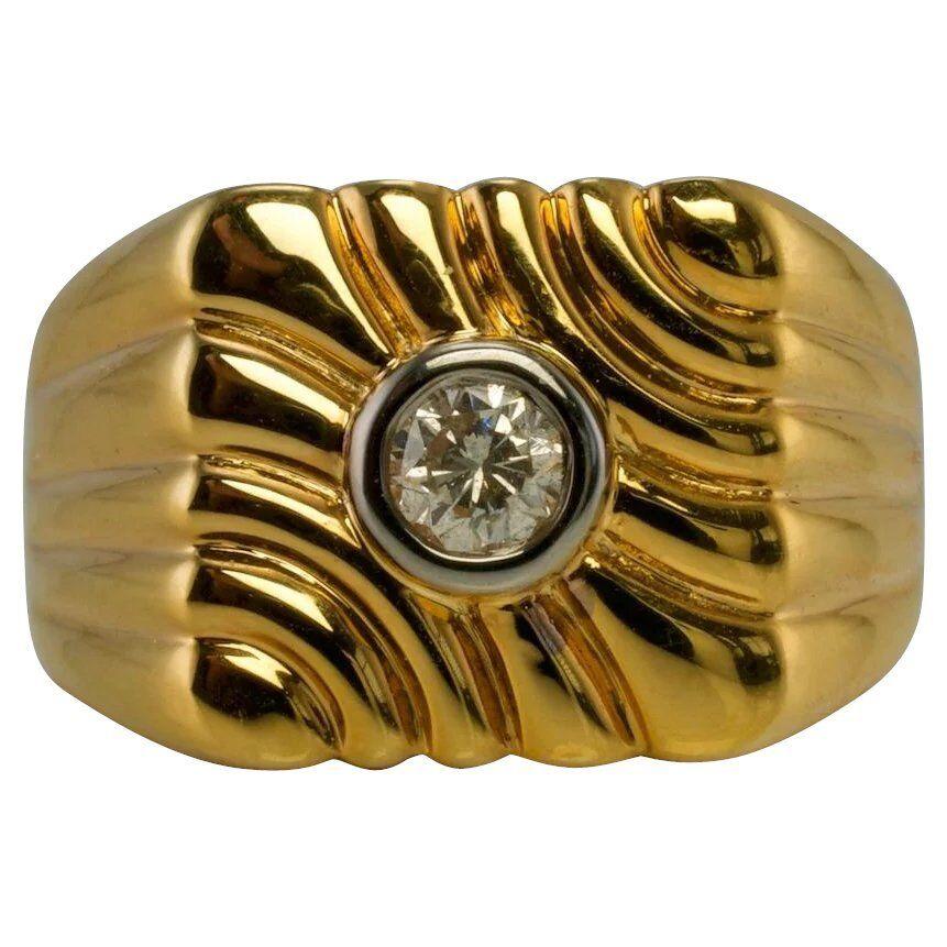 This beautiful ring for a gentleman is finely crafted in solid 14K Yellow gold and set with a diamond in the center. The bezel set .25 carat diamond is estimated to be SI2 clarity and H color. The top of the ring measures 13mm North-South, the band