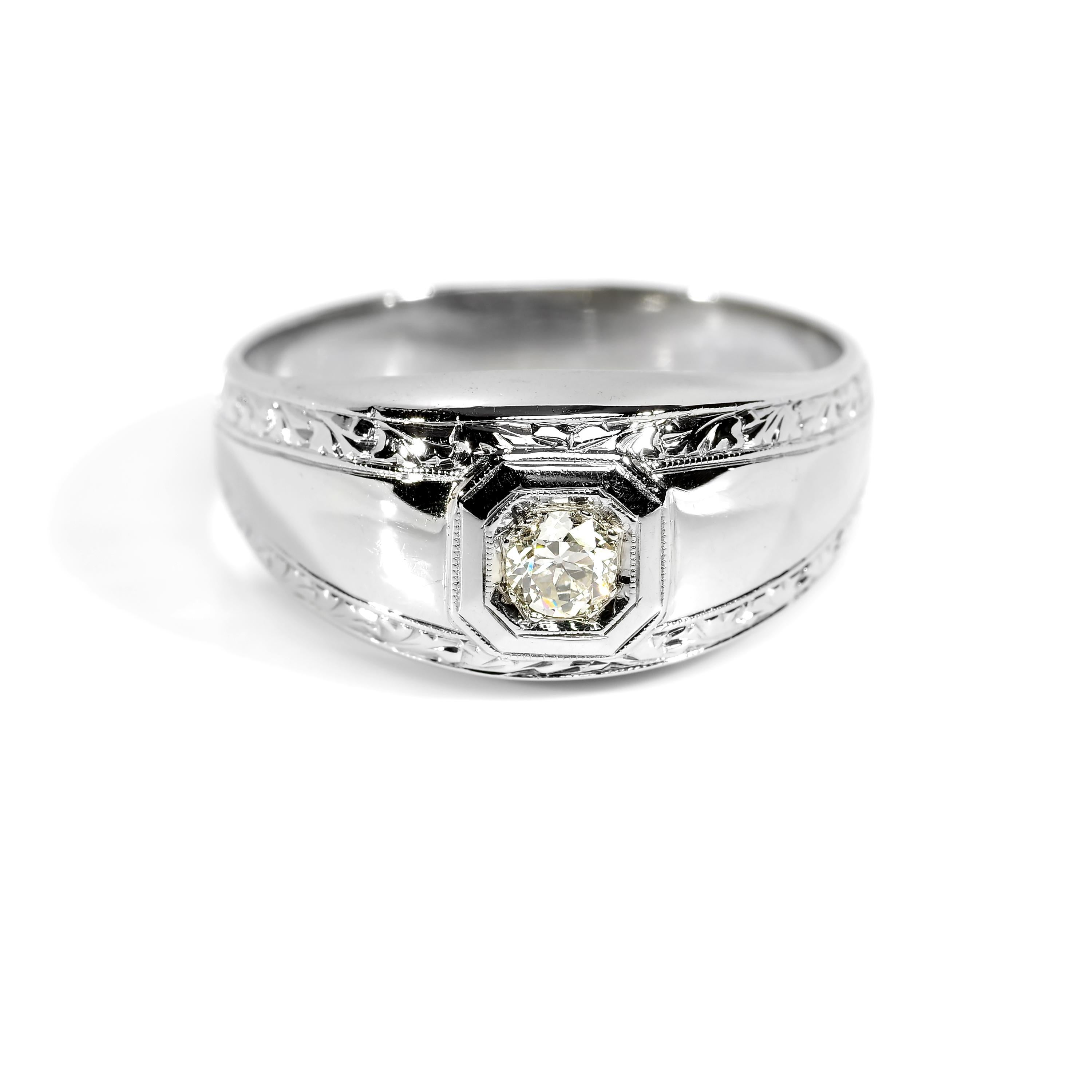 Sleek and aerodynamic, this 18K white gold and diamond men's ring from the Art Deco era is the very definition of understated elegance. 

A firey near-colorless (G/H) eye-clean (VS) old European-cut diamond weighing .20 carats is prong-set within a