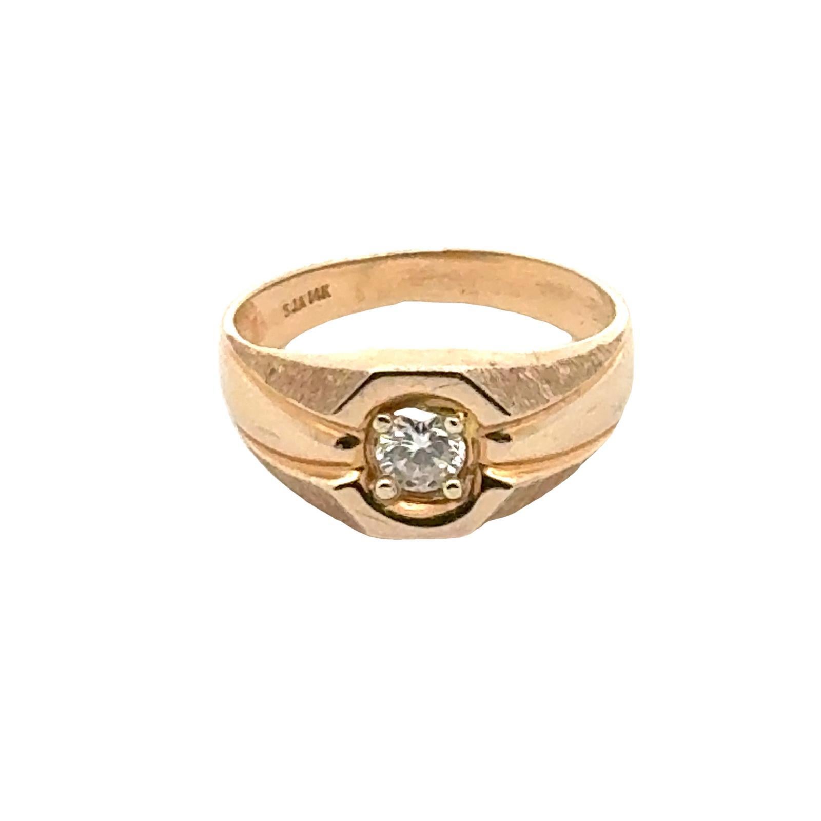 This vintage men's ring is a testament to timeless style and sophistication. Crafted from 14 karat yellow gold, the ring features an approximate .34 carat round brilliant cut diamond graded I color and SI1 clarity. The diamond is securely set in a