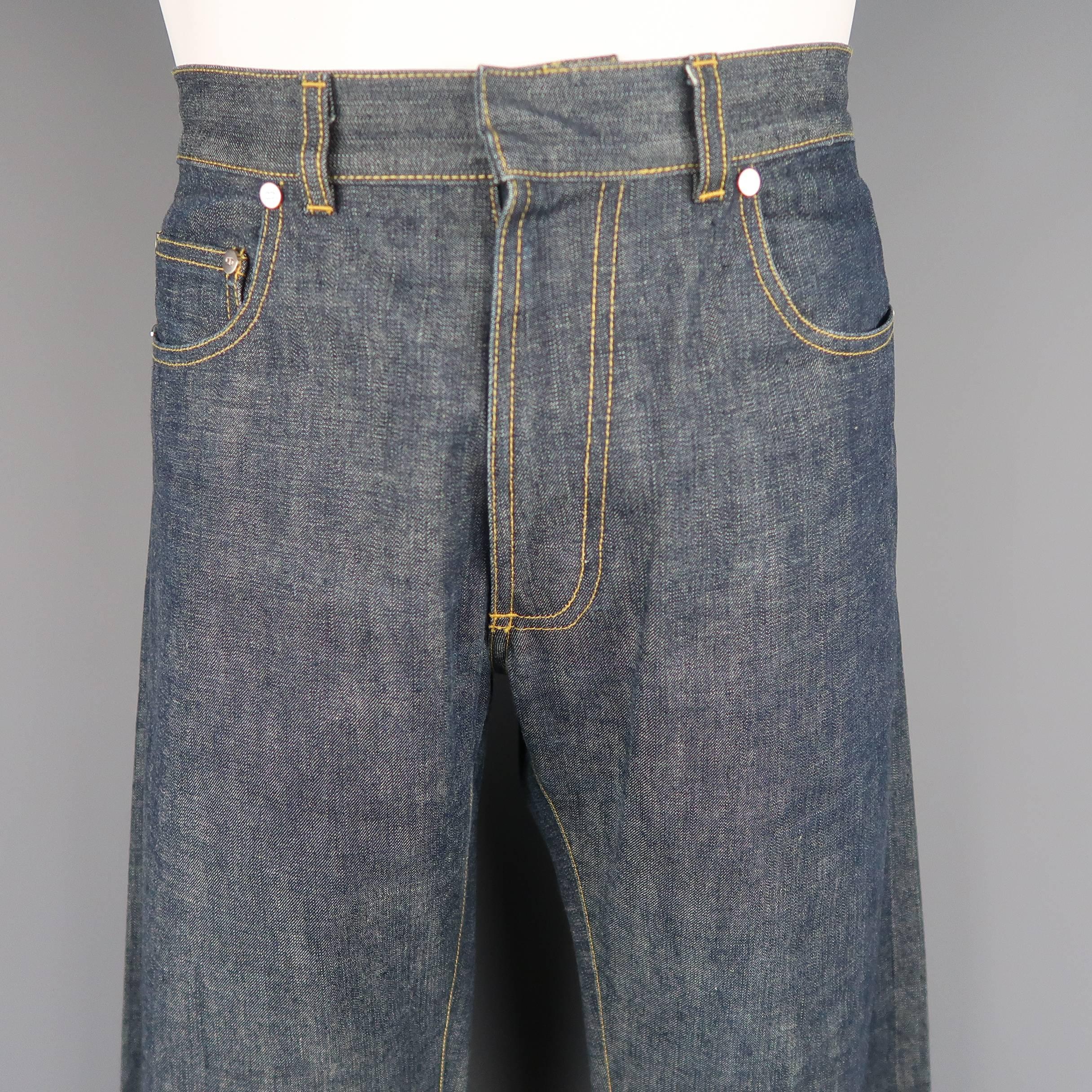 DIOR HOMME straight leg jeans come in a light weight ash blue selvedge denim with yellow contrast stitching and silver tone engraved hardware. Mad in France.
 
Excellent Pre-Owned Condition.
Marked: 48
 
Measurements:
 
Waist: 34 in.
Rise: 9.5