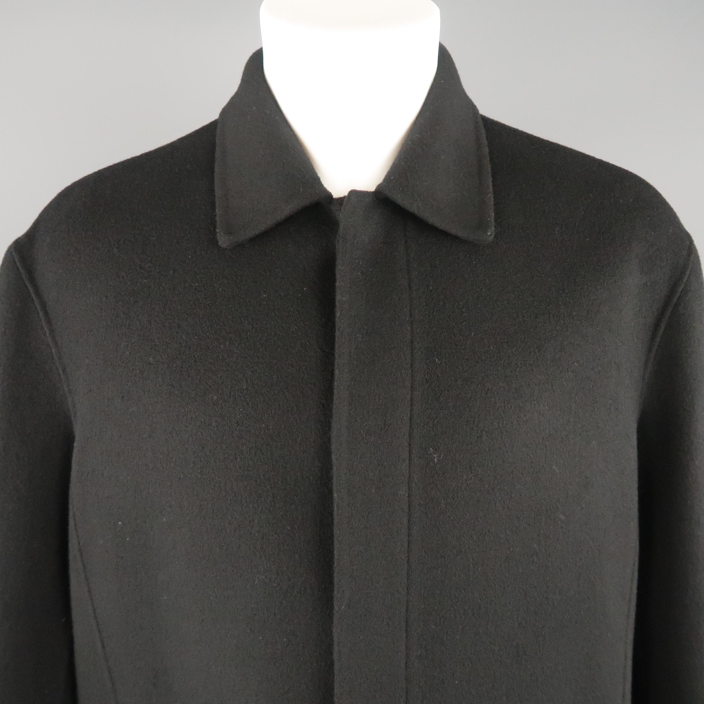 DONNA KARAN car coat comes in double face wool felt with a pointed collar, slit pockets, and hidden placket button up front.
 
Excellent Pre-Owned Condition.
Marked: M
 
Measurements:
 
Shoulder: 21 in.
Chest: 56 in.
Sleeve: 24 in.
Length: 36 in.