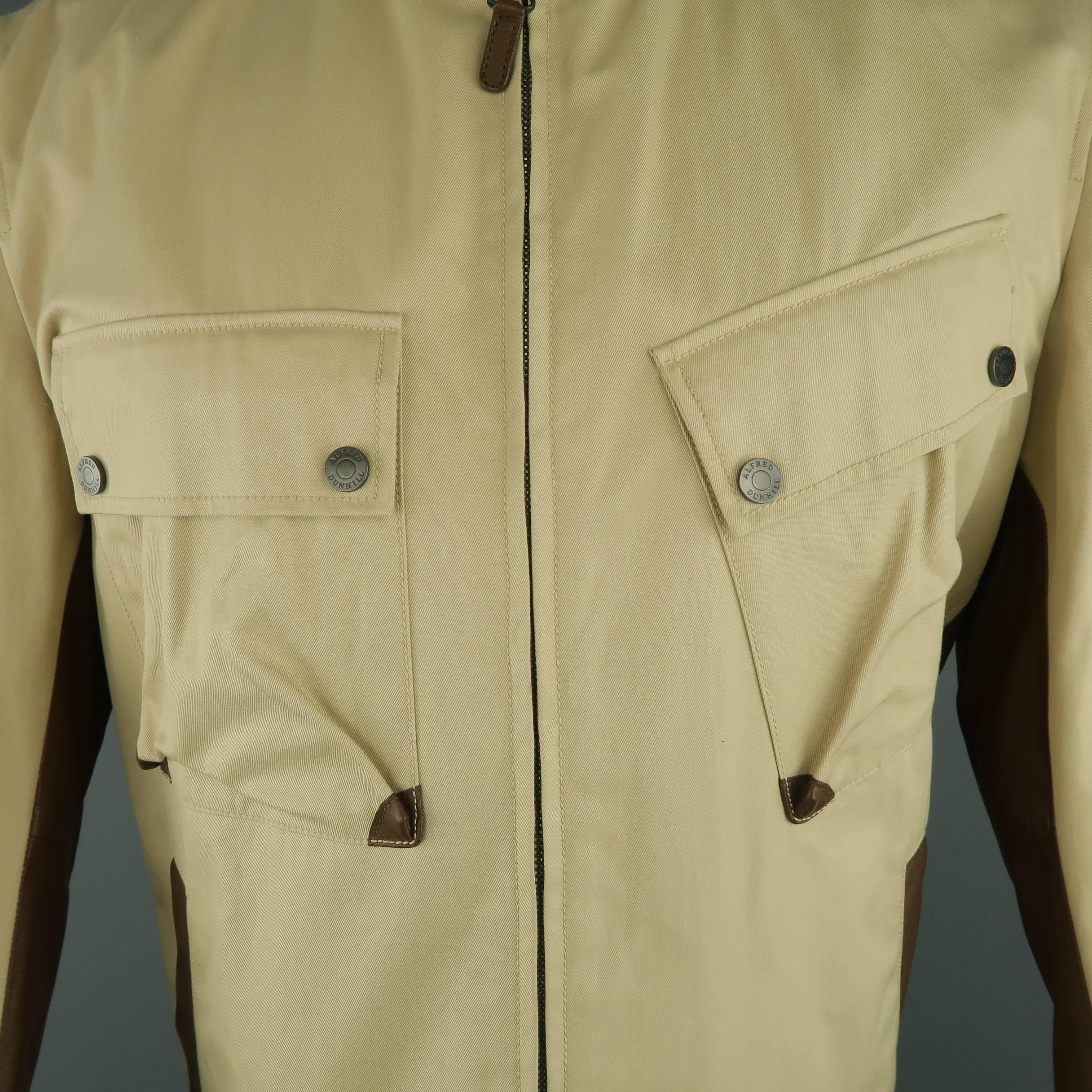 DUNHILL motorcycle style jacket comes in khaki twill canvas  and features a brown leather band collar, double chest flap pockets, slanted slit pockets, and leather side panels. Small spot at bottom front. As-is.
 
Good Pre-Owned Condition.
Marked: