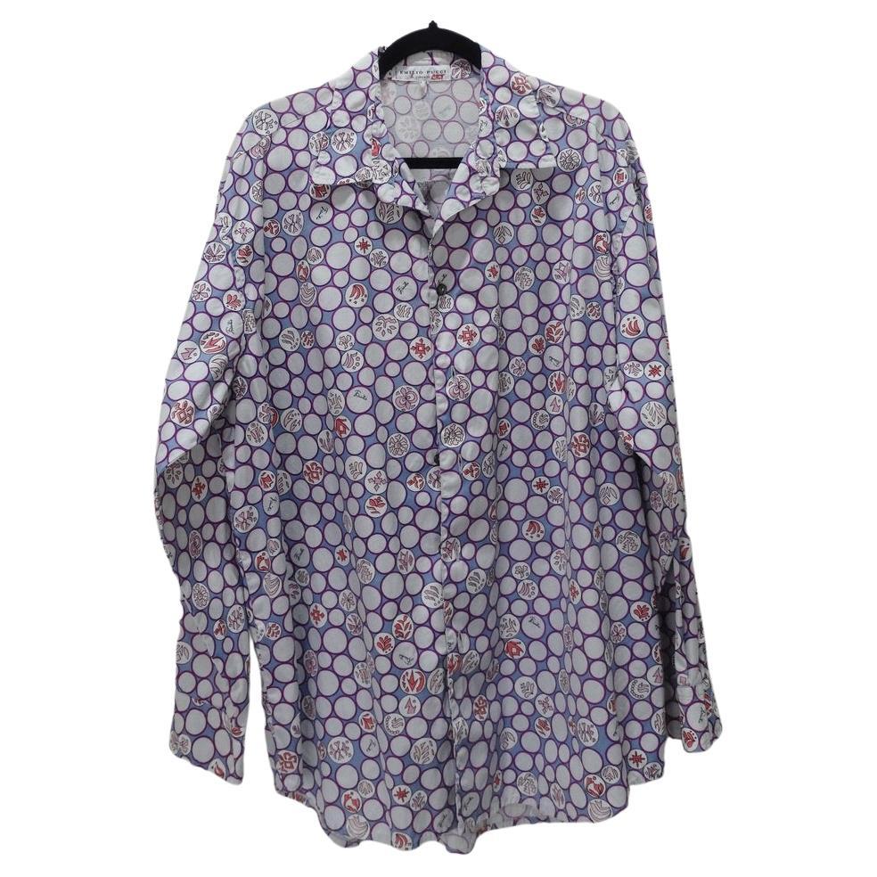 Vintage mens Emilio Pucci long sleeve printed button up shirt. Featuring a classic Pucci monogram print in a pastel purple, white and red. The structured collar and buttons down the middle allow for versatility with styling. This is a great timeless