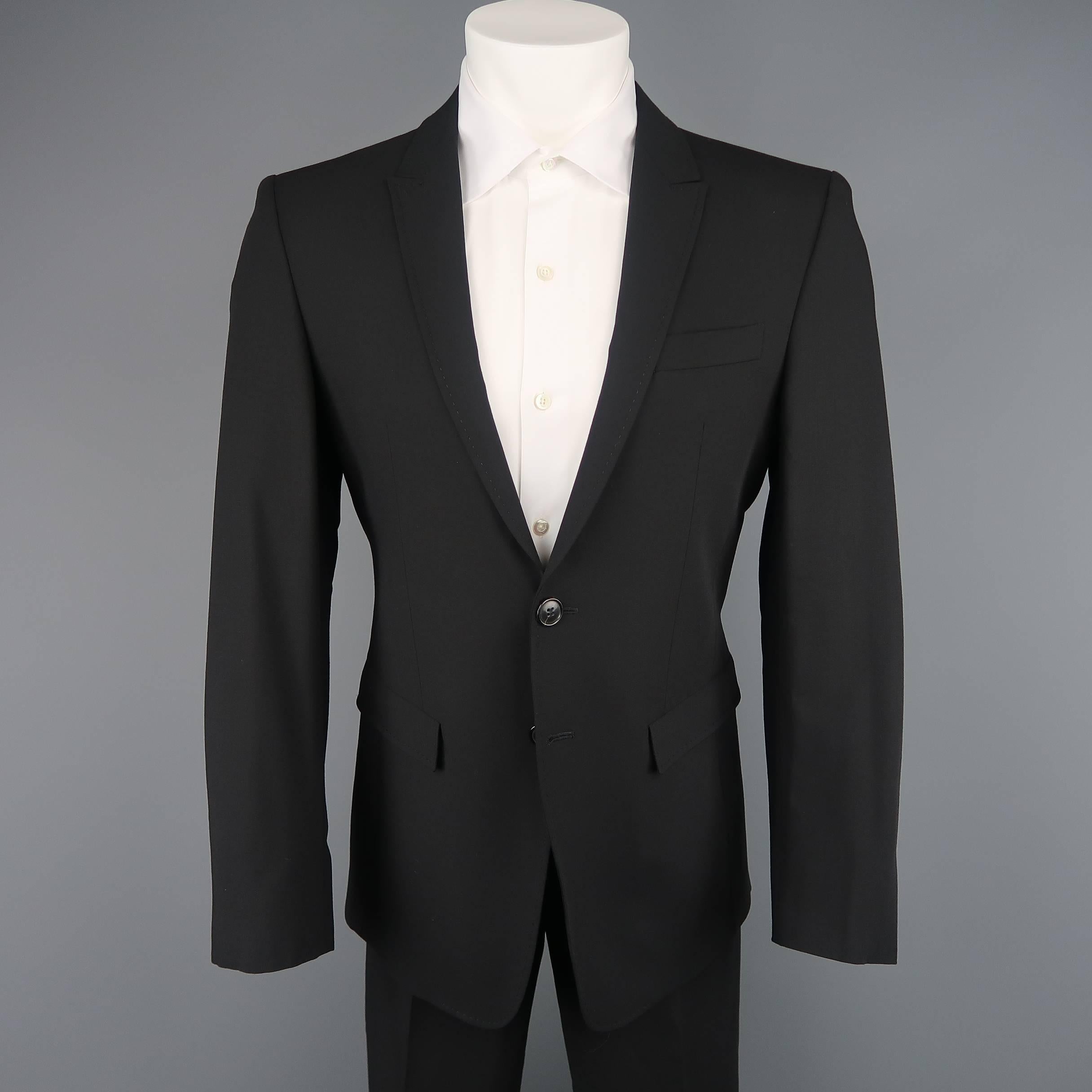 Two piece suit by EMPORIO ARMANI- ITALIA LINE comes in black wool and includes a single breasted two button sport coat with peak lapel and matching flat front trousers.  Made in Italy.
 
Excellent Pre-Owned Condition.
Marked: 40
 
Measurements:
