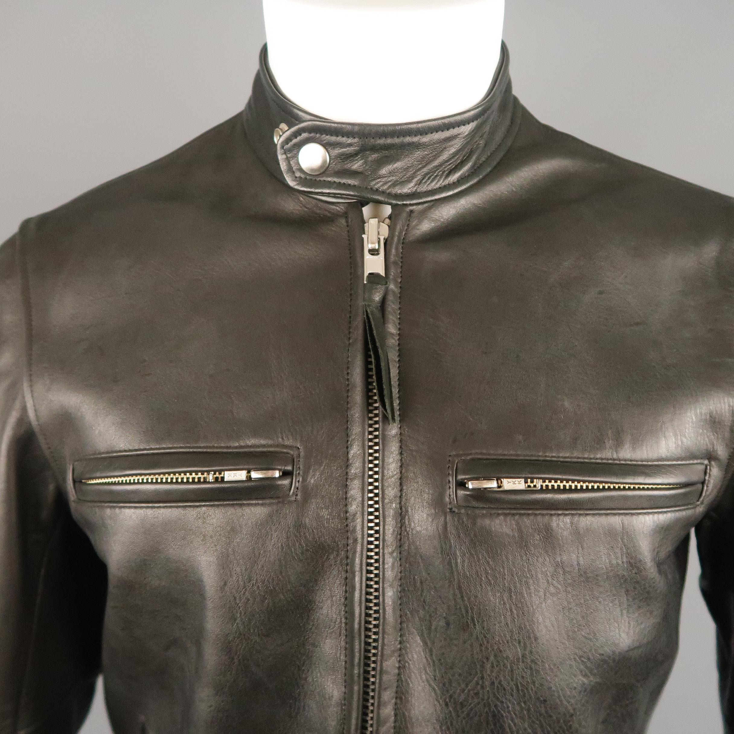 EPAULET motorcycle jacket comes in Horween horsehide leather snap tab band collar, double zip front, zip chest pockets, zip cuffs, slanted slit pockets, and plaid liner. Minor wear throughout leather. Made in USA.
 
Very Good Pre-Owned