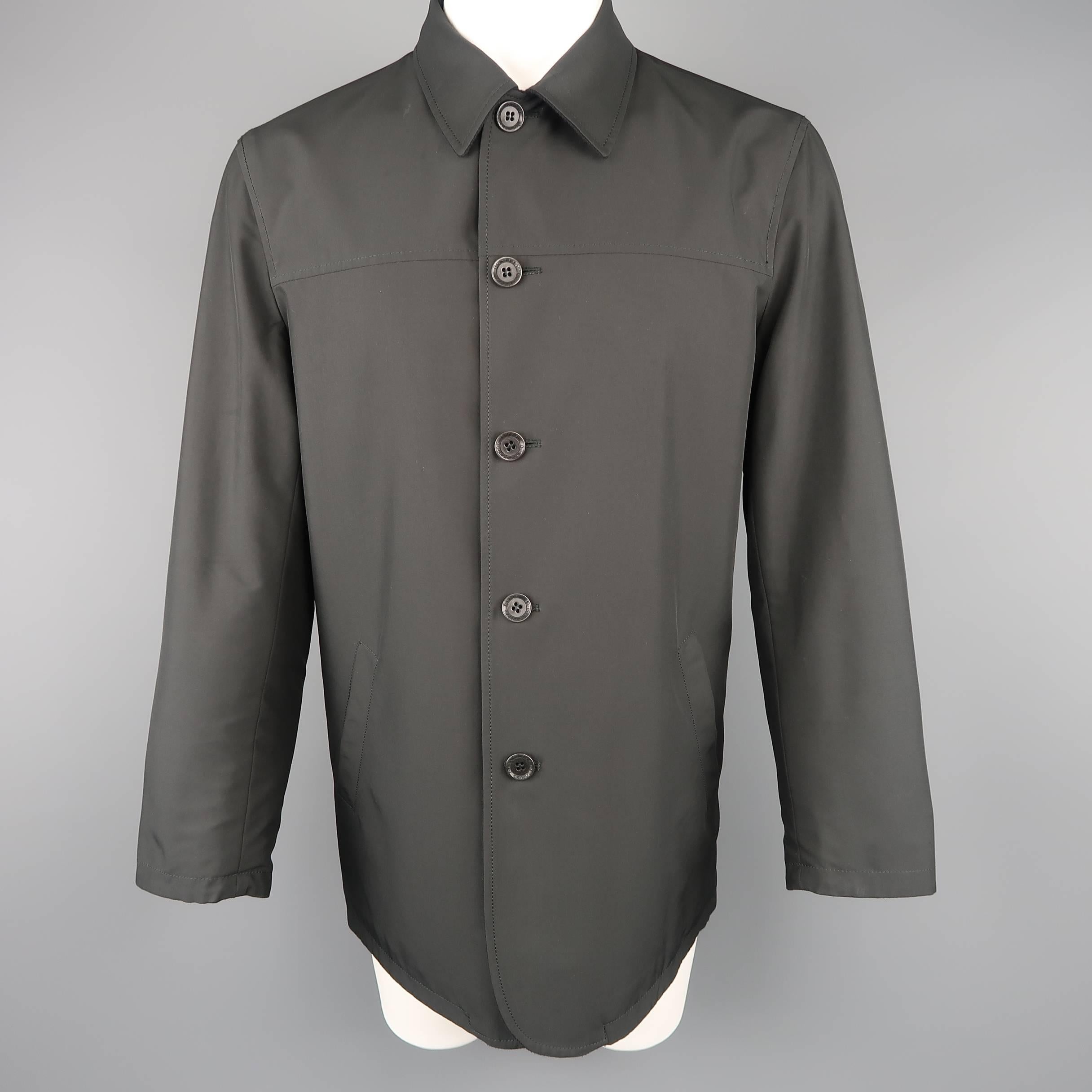 Reversible ERMENEGILDO ZEGNA car coat features a black wool cashmere side with pointed collar and patch pockets and a reverse nylon interior with slit pockets. Minor wear on nylon. Made in Italy.
 
Good Pre-Owned Condition.
Marked: S/48
